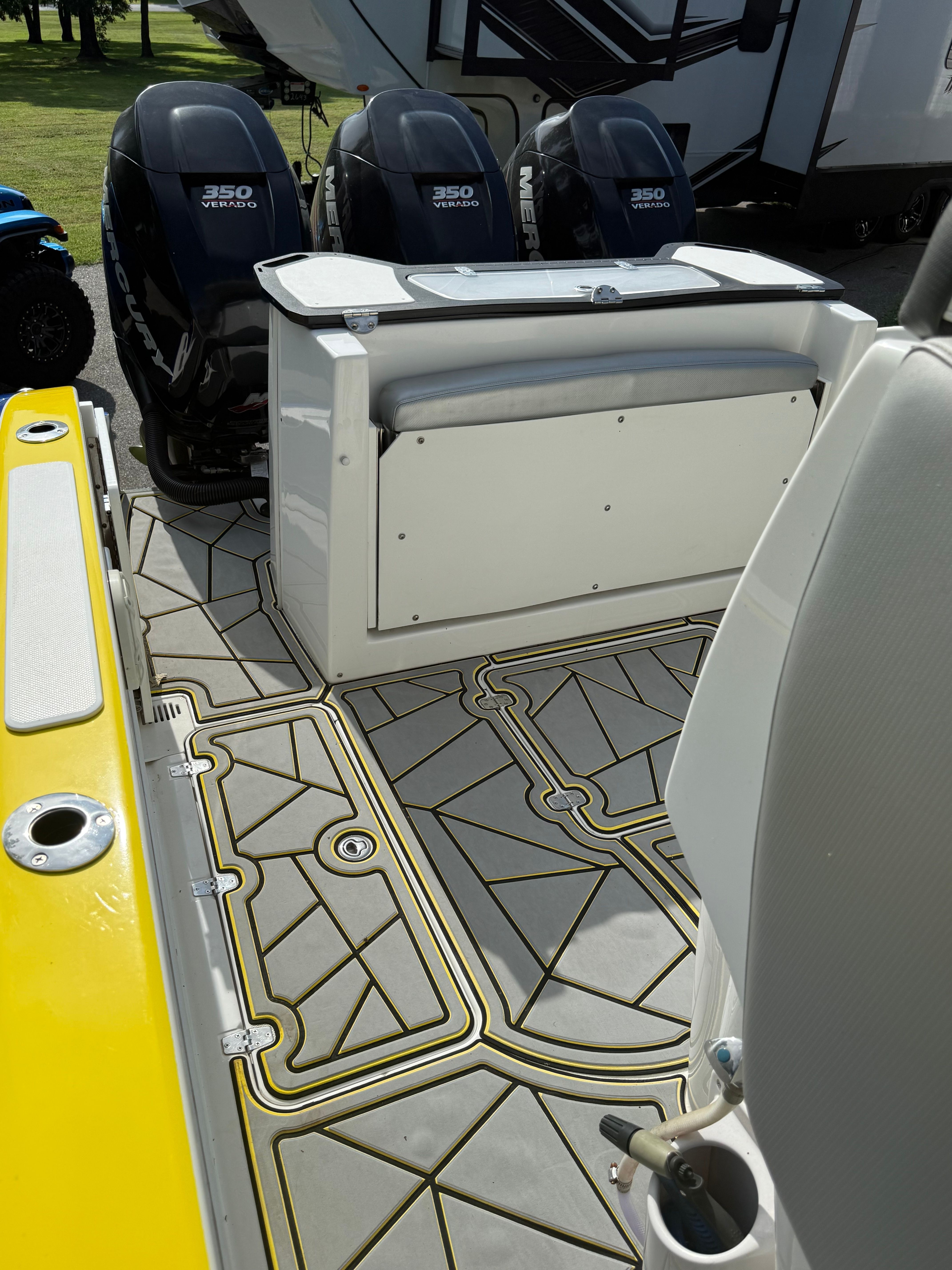 The image shows the deck of a 2014 Sunsation 34 CCX with three outboard engines.