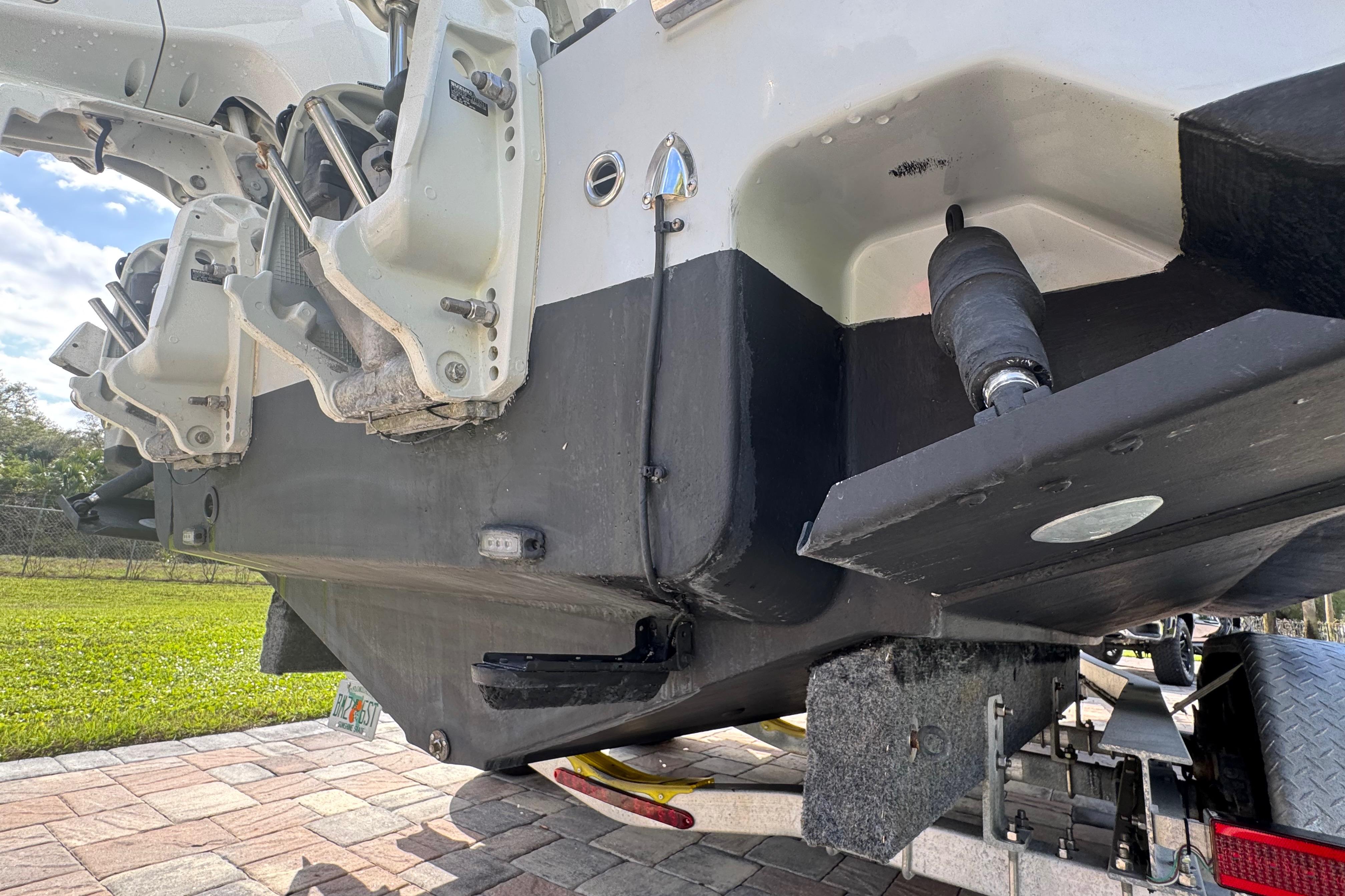 2022 Aquasport 2500 Center Console boat on trailer, showing hull and engine details.