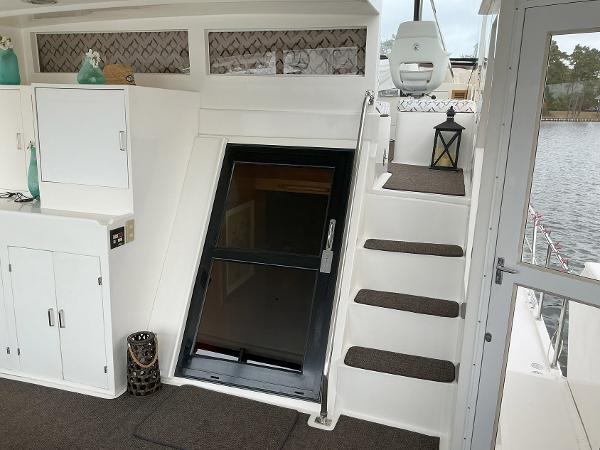 Novatec Islander 55 yacht interior, featuring stairs, cabinets, and decorative elements, 2000 model.