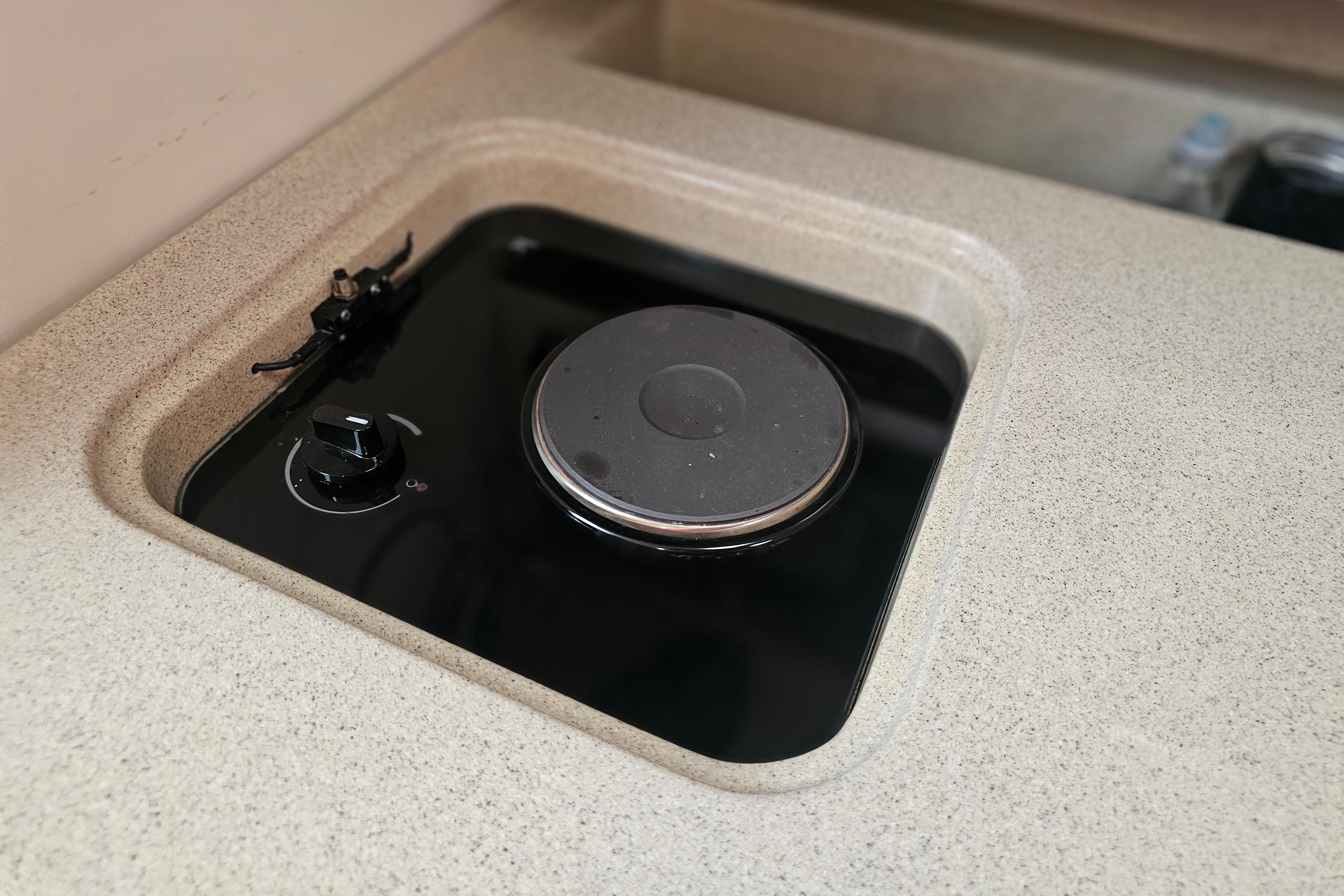 Electric stove on 2001 Pursuit 3000 Express boat, featuring a sleek countertop design.