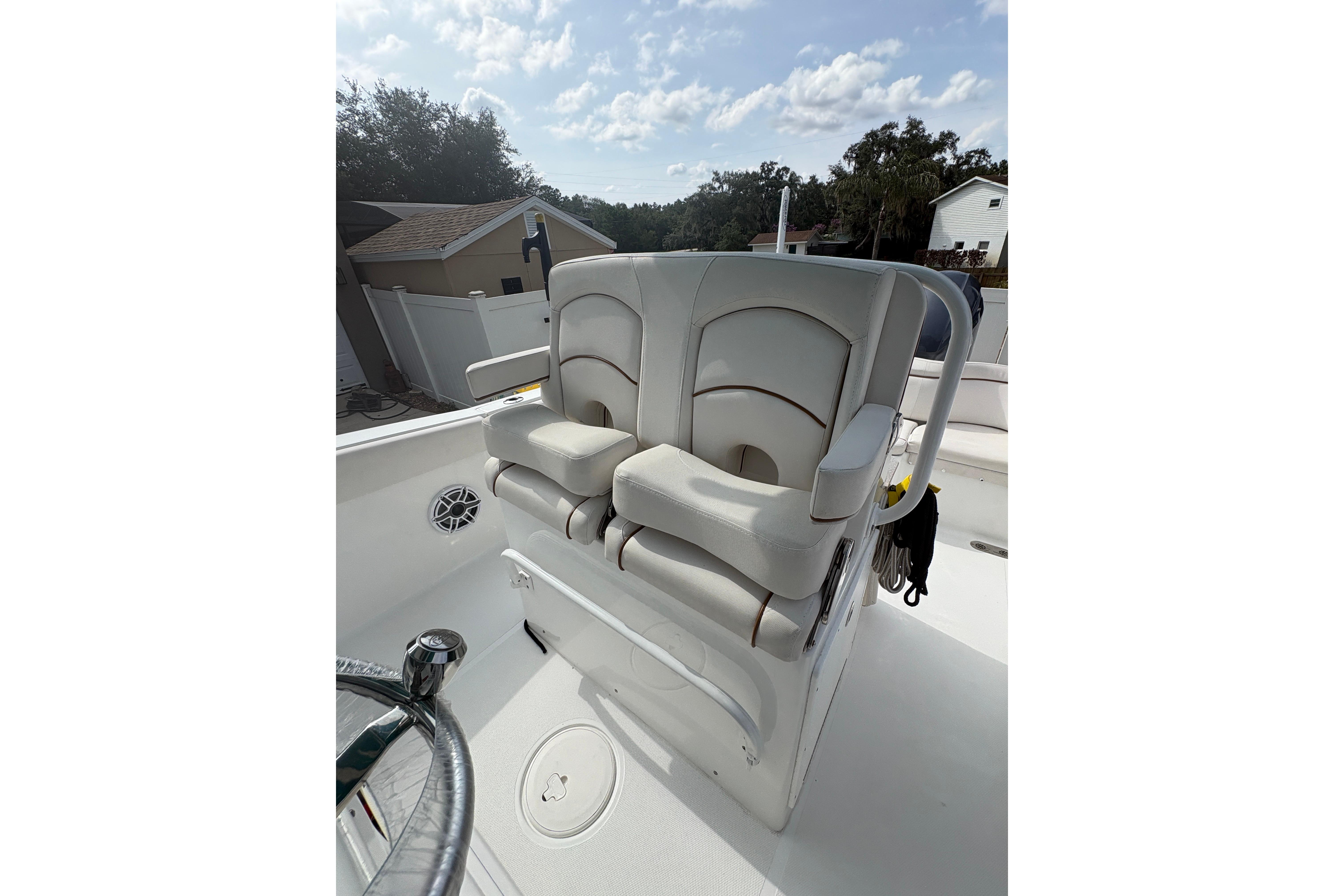 2021 Sea Hunt Ultra 265 SE boat with dual cushioned seats and steering wheel.