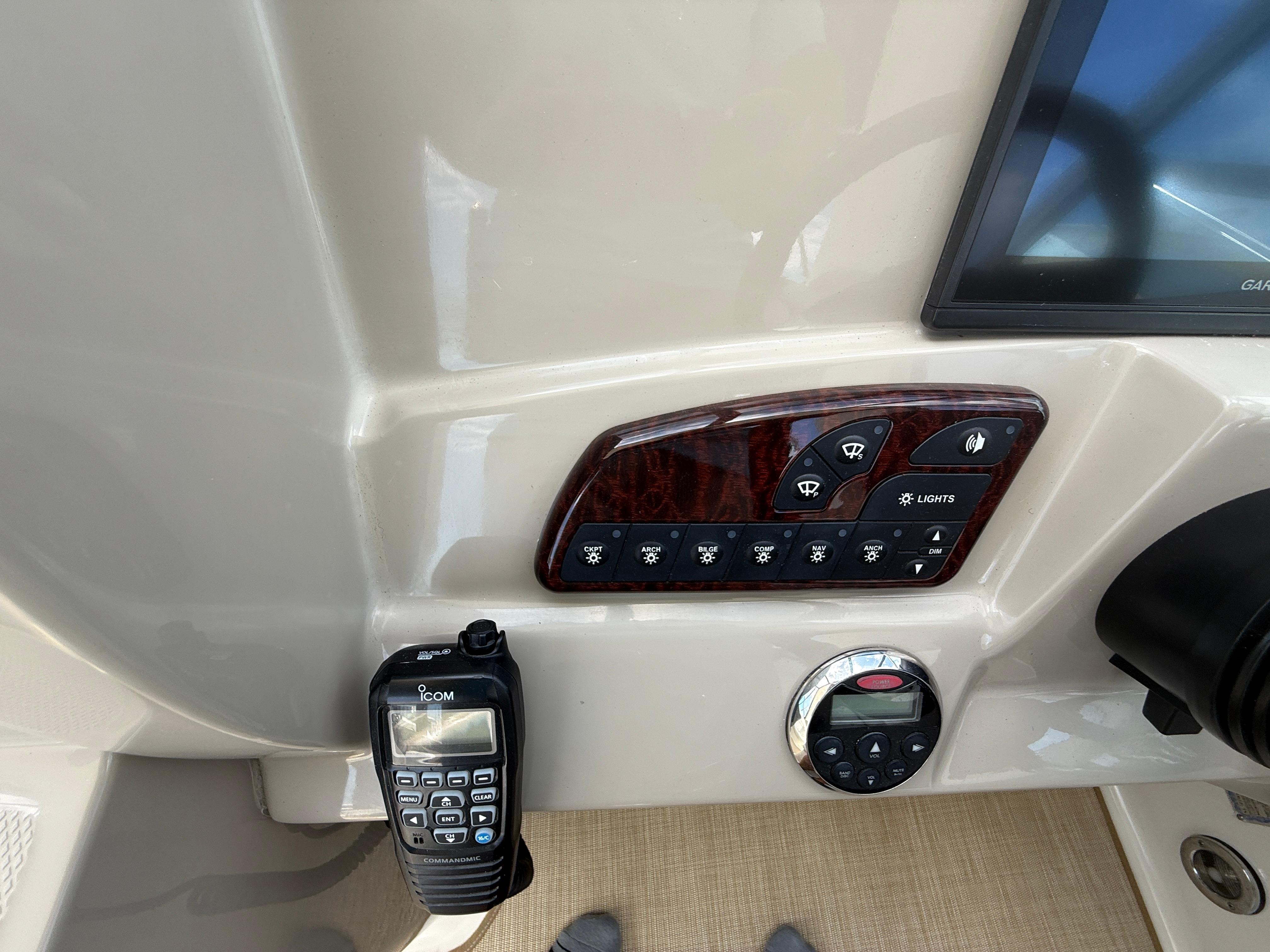 Control panel of a 2006 Sea Ray 290 Sundancer boat with radio and switches.