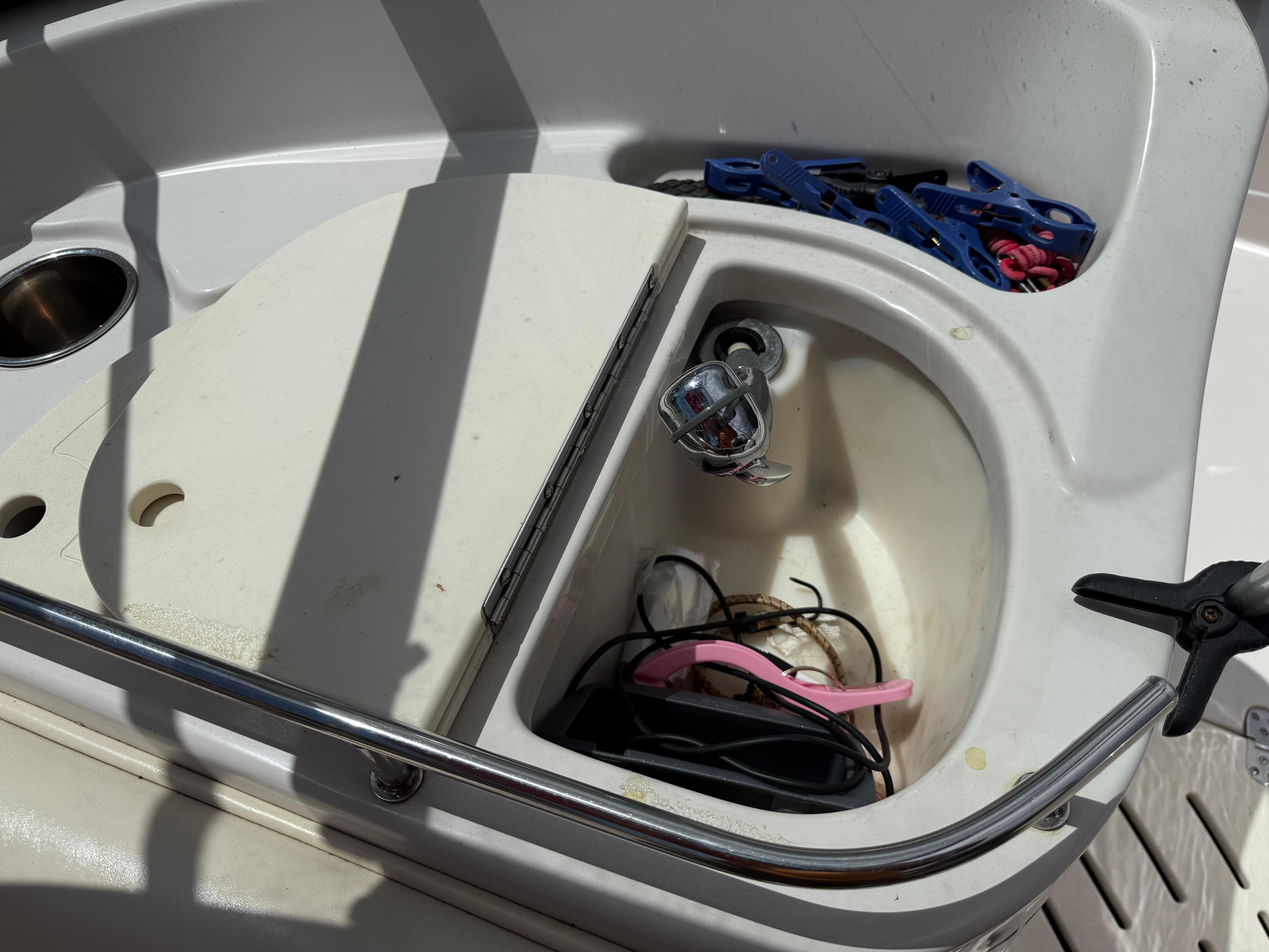Interior of a 2011 Tahoe 216 WT boat with sink and accessories.