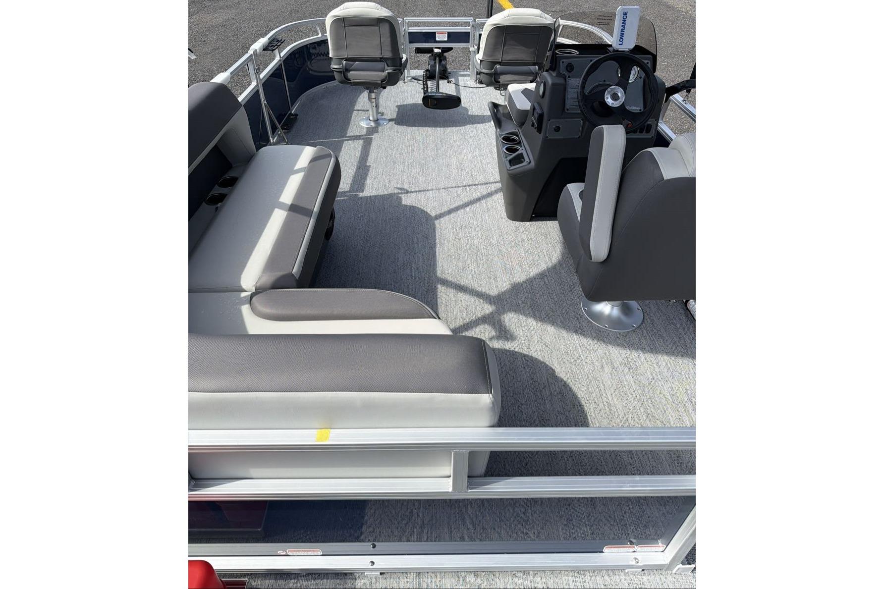 2026 Sun Tracker Bass Buggy 16 XL Select pontoon boat interior with seating and steering console.