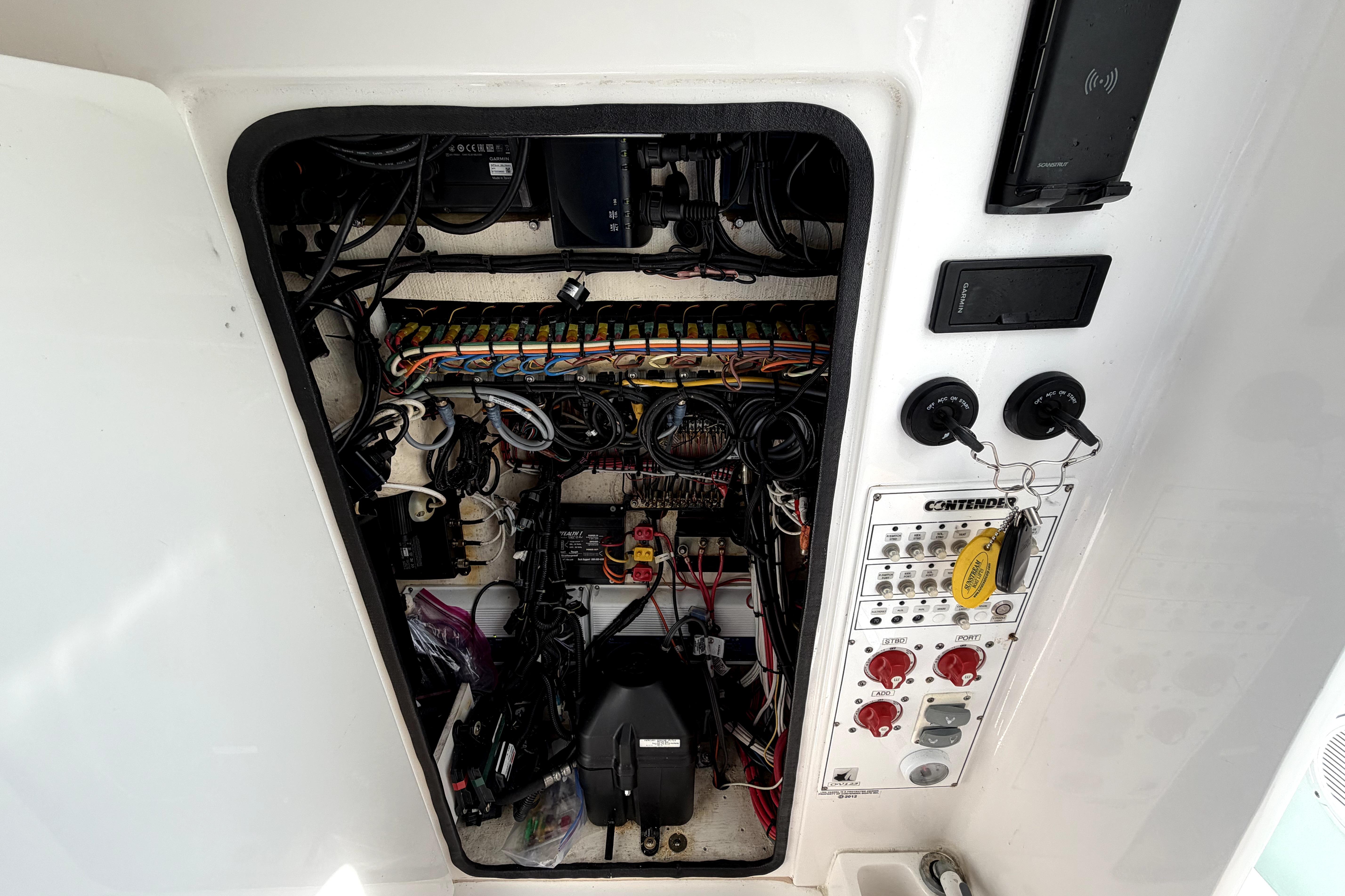 Electrical panel of a 2019 Contender 30 ST boat, showcasing wiring and controls.
