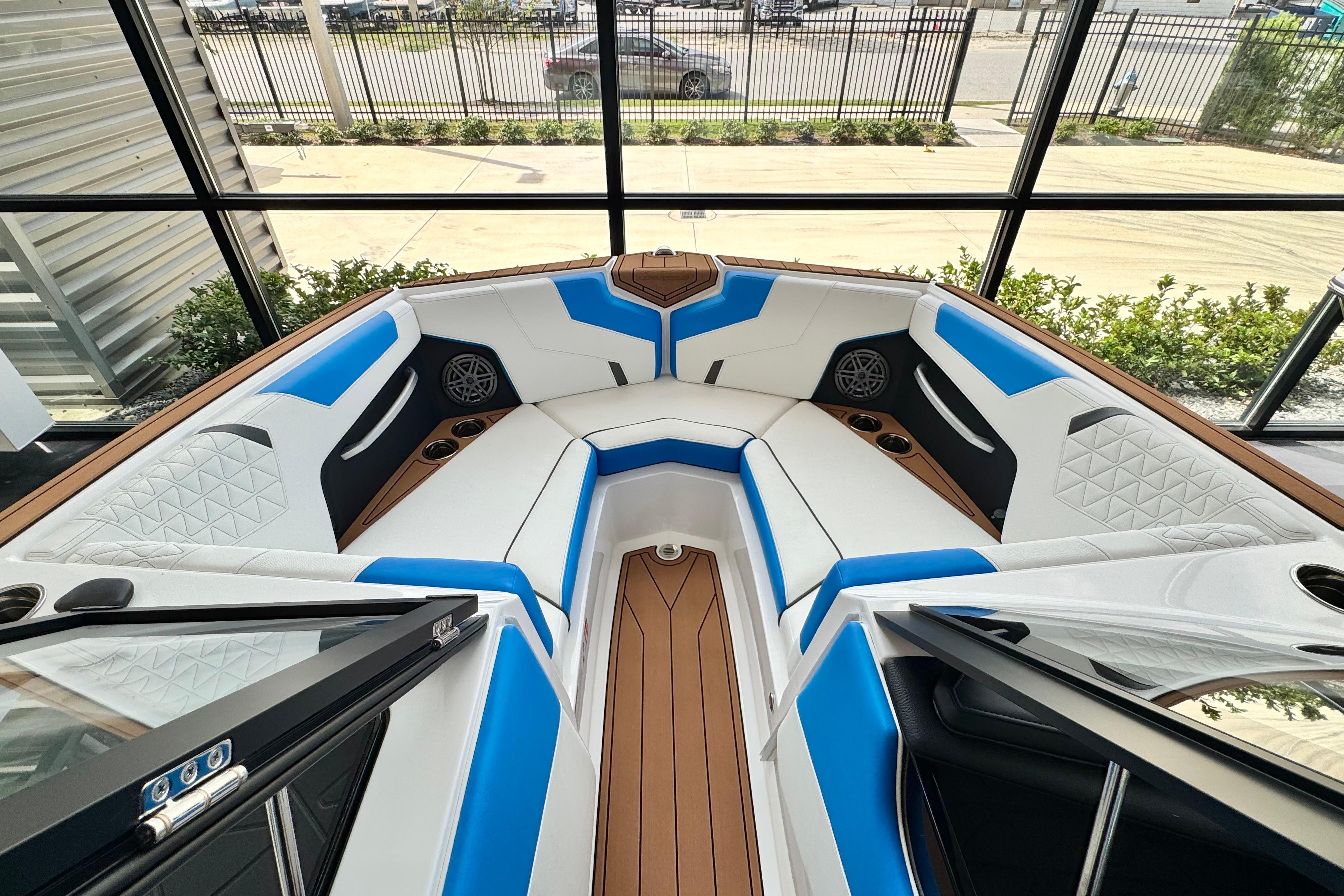 2026 Nautique Super Air Nautique GS22 interior with blue and white seating, wood accents.