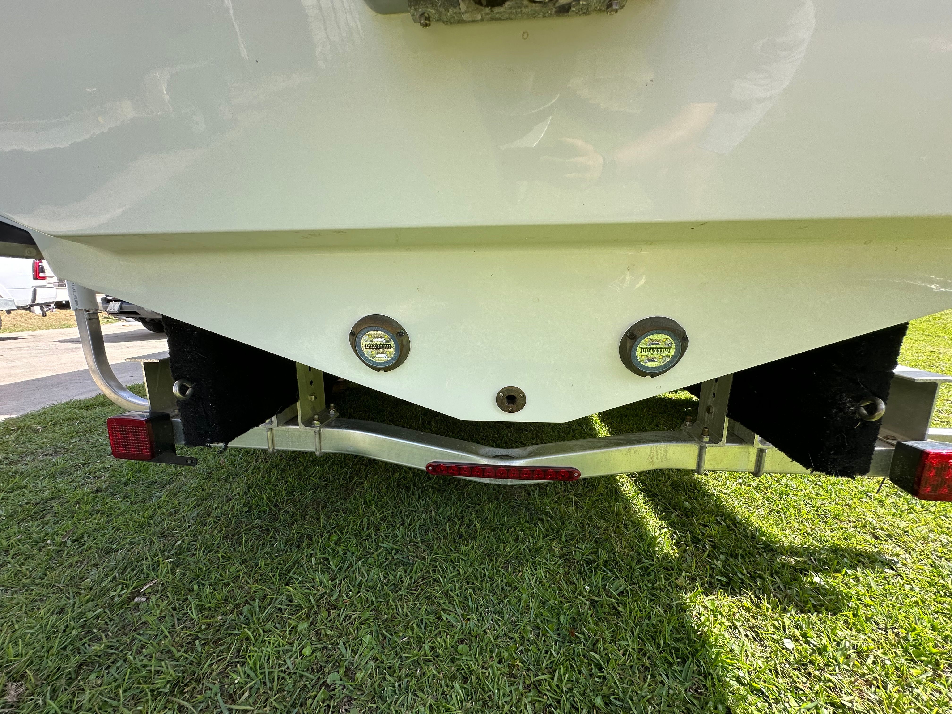 Rear view of Blackfin 252 DC boat trailer, 2024 model, on grass.