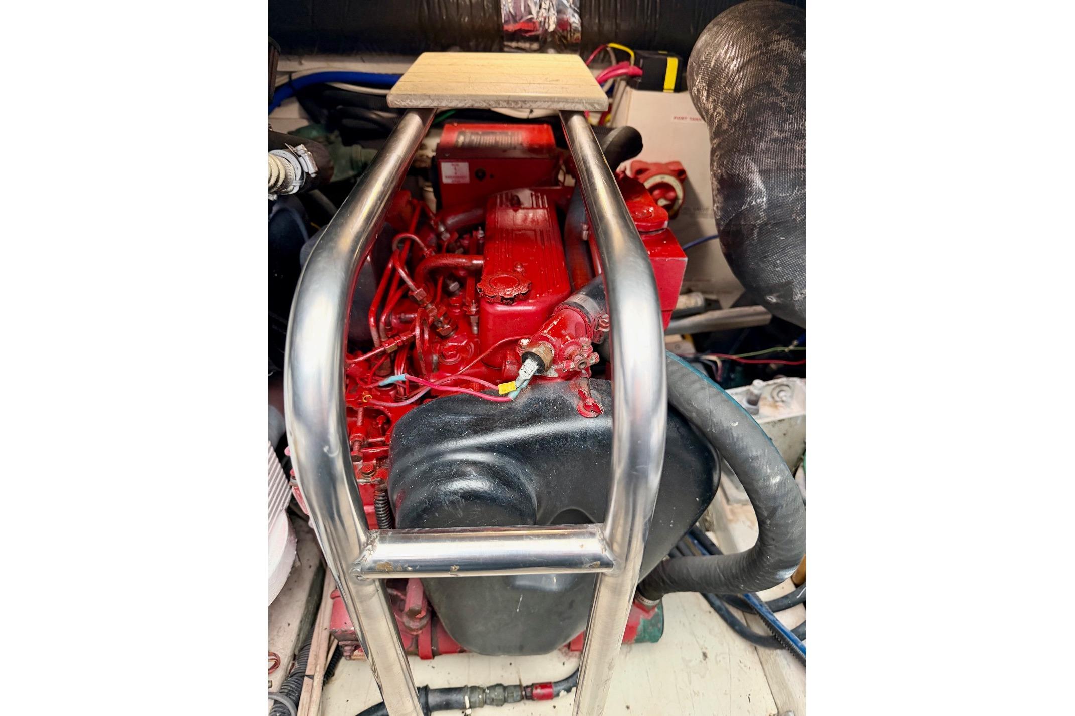 Engine compartment of a 2003 Tiara Yachts 3500 Open, featuring a red engine.