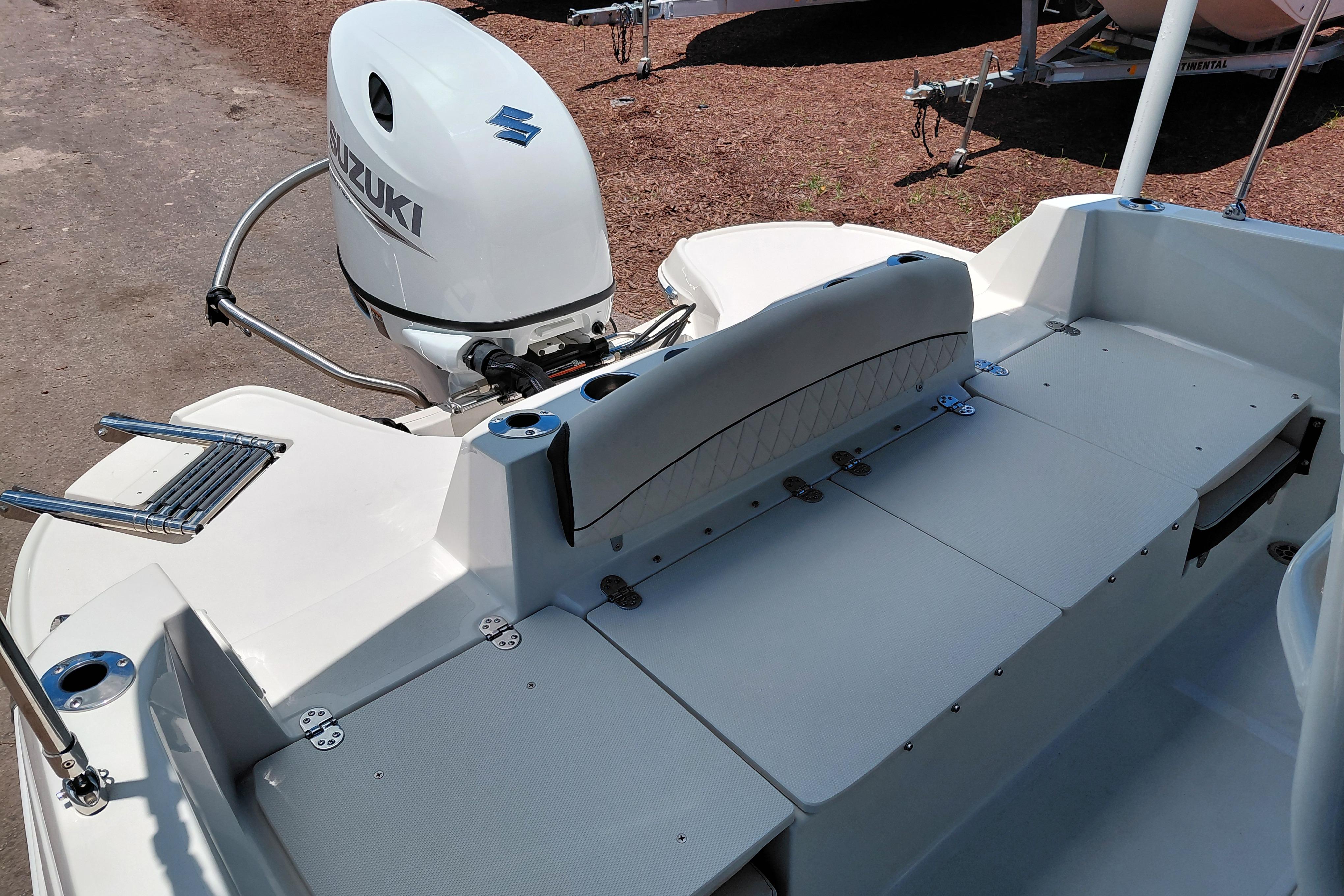 2023 Stingray 206 CC boat with Suzuki outboard motor, featuring spacious seating and deck.