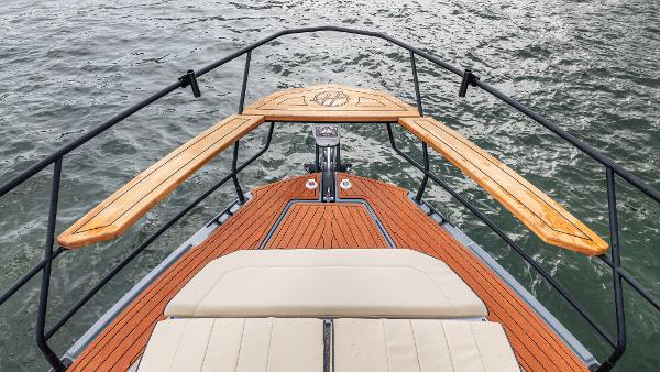 Front deck of a 2026 Hanover 415 boat with wooden trim.