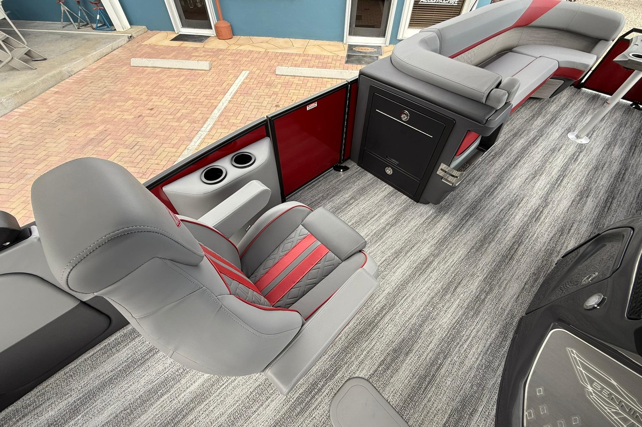 2026 Bennington 26 M Center Swingback boat interior with gray and red seating, modern design.