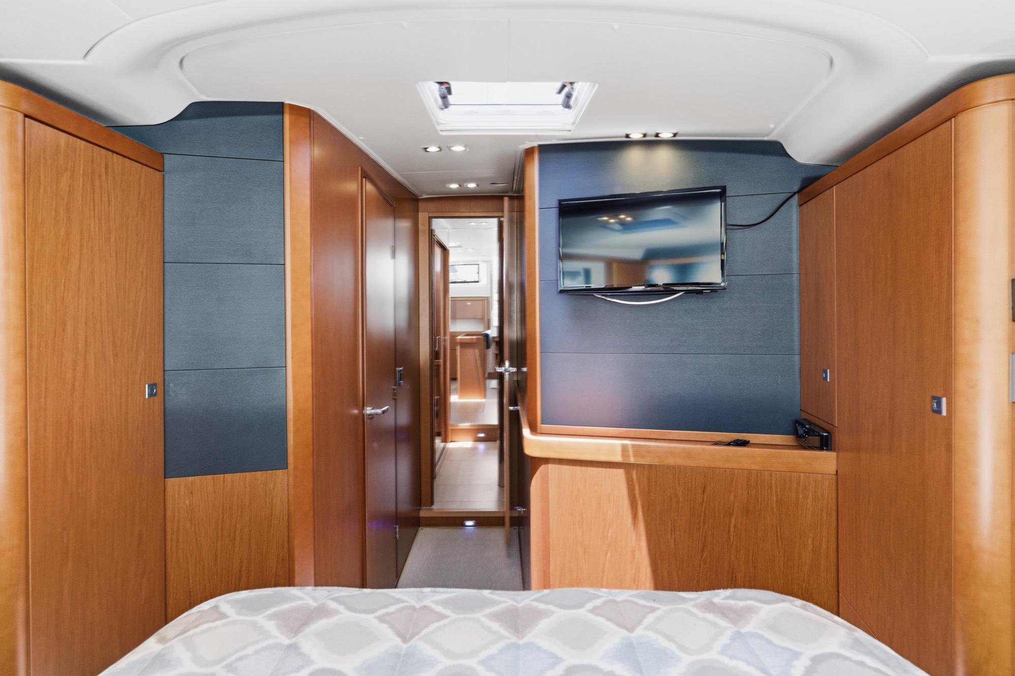 Luxurious interior of 2017 Beneteau Sense 50 yacht with wood paneling and mounted TV.