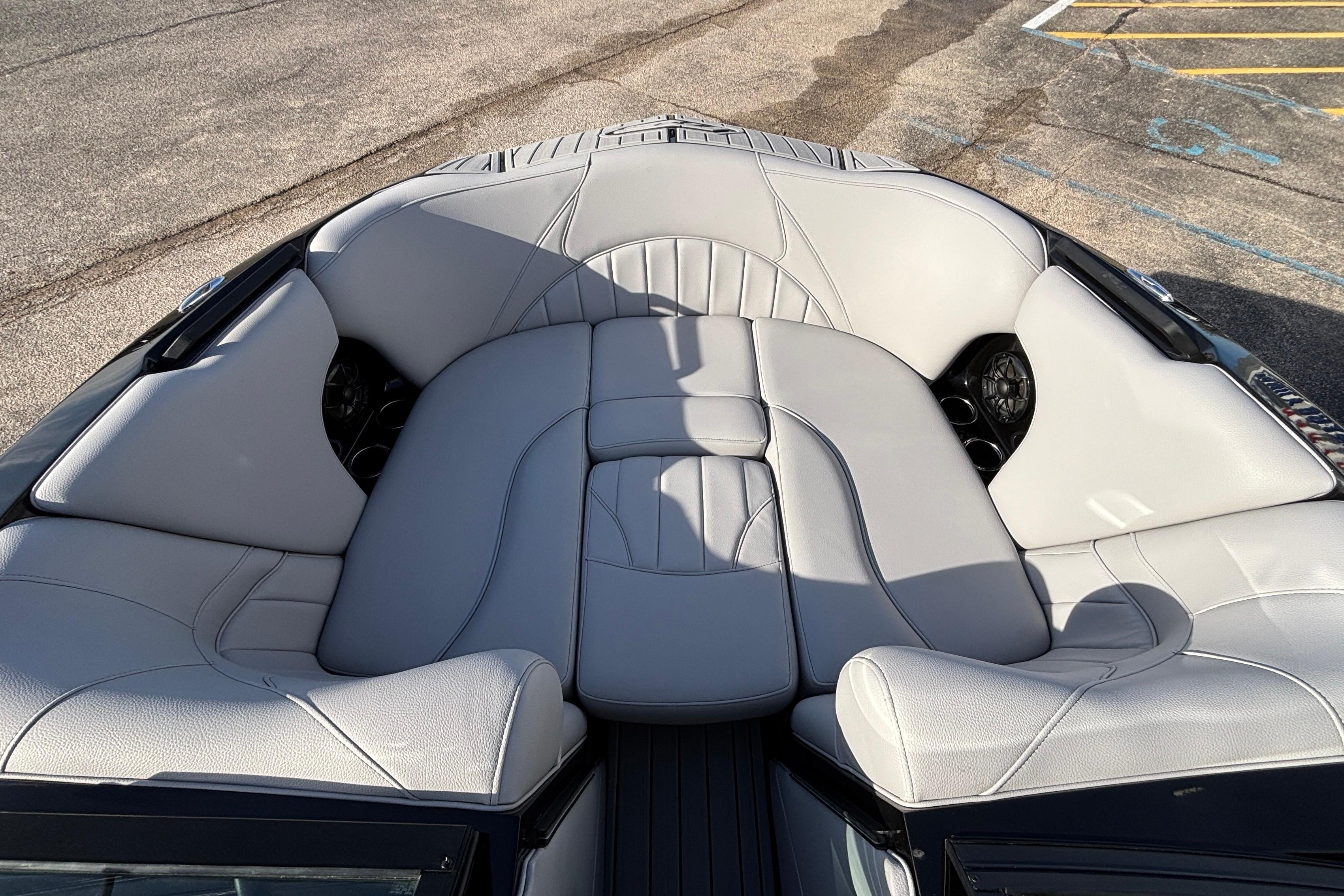 2026 MB B52 23 Classic boat interior with luxurious gray seating and cup holders.