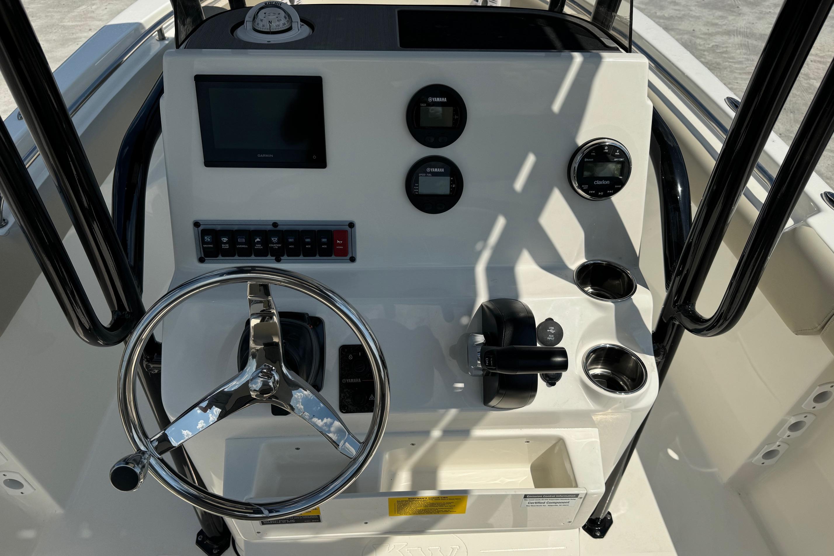 2025 Key West 203 FS boat dashboard with steering wheel and control panel.
