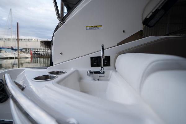2016 Regal 28 Express boat interior with sink and cup holders.