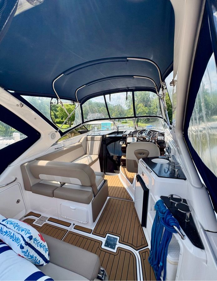 Interior of a 2014 Regal 30 Express with blue upholstery and wood flooring.