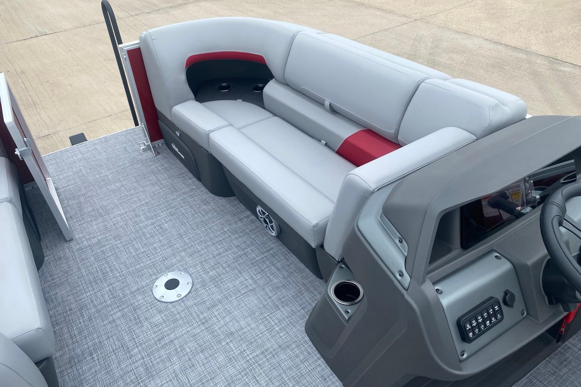 2026 Sun Tracker Party Barge 22 RF DLX interior with gray seating and modern dashboard.