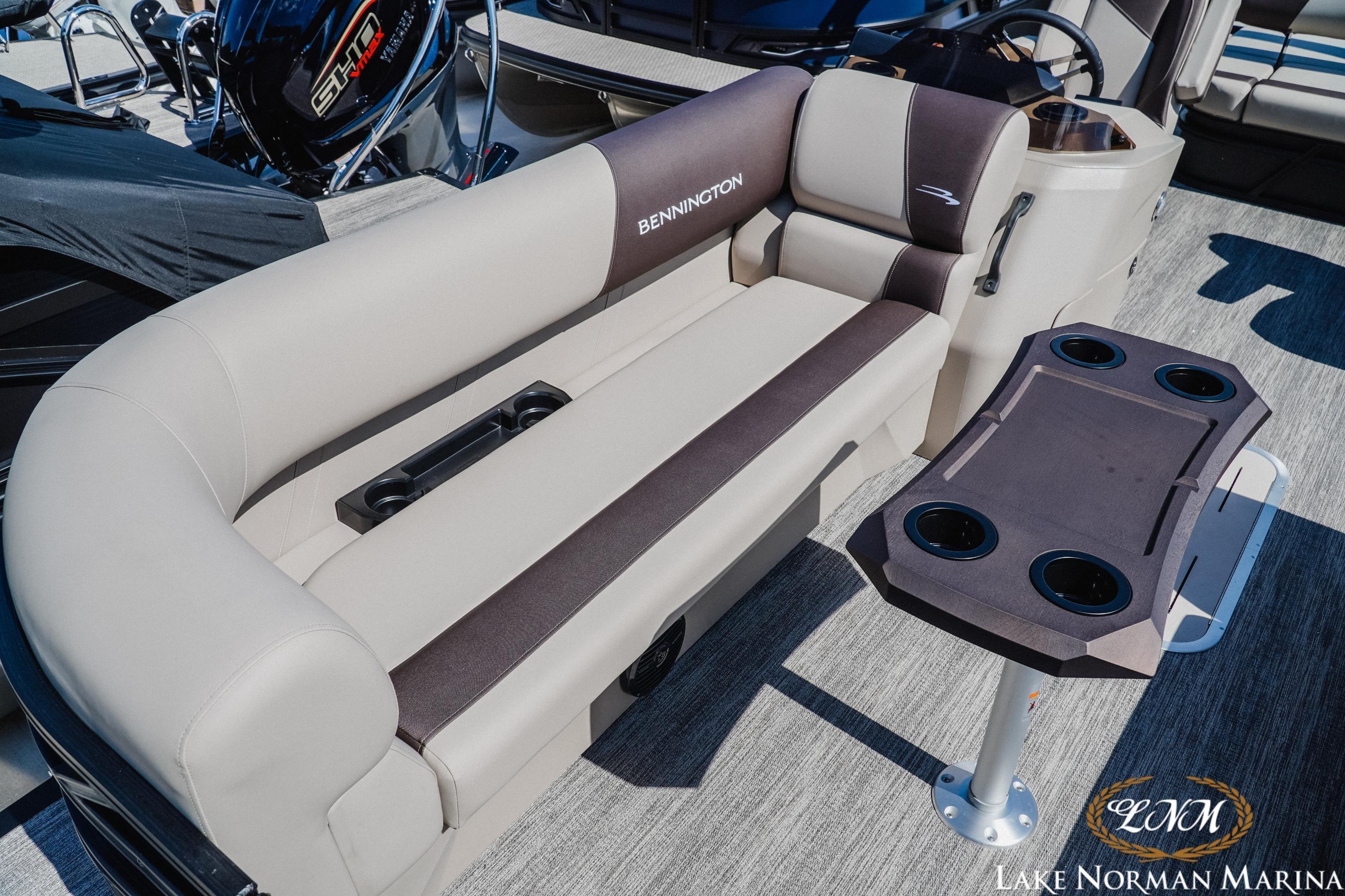 2027 Bennington 23SSB pontoon boat interior with plush seating and cupholder table at Lake Norman Marina.