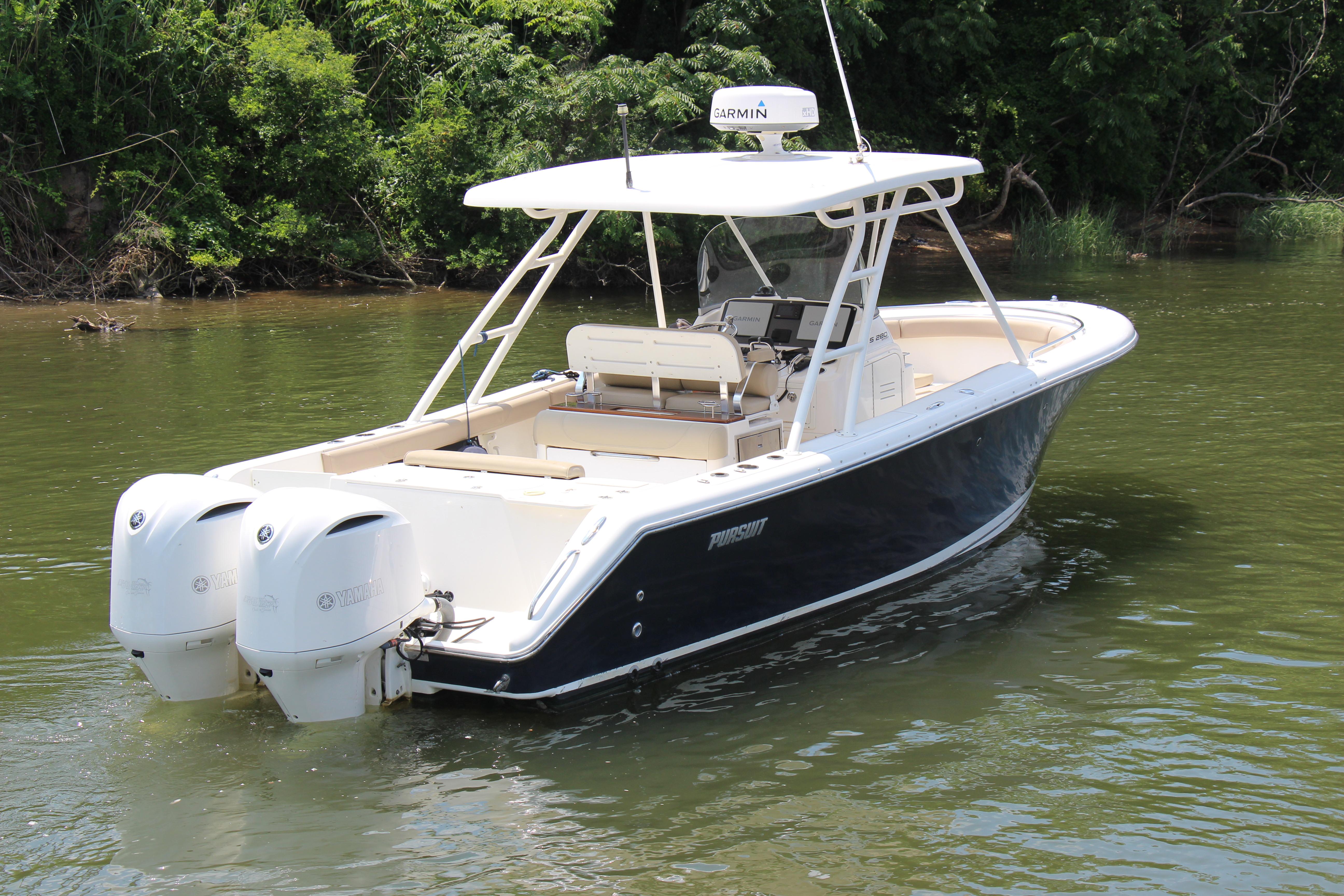 2016 Pursuit S 280 Sport boat with dual Yamaha engines on a calm river.
