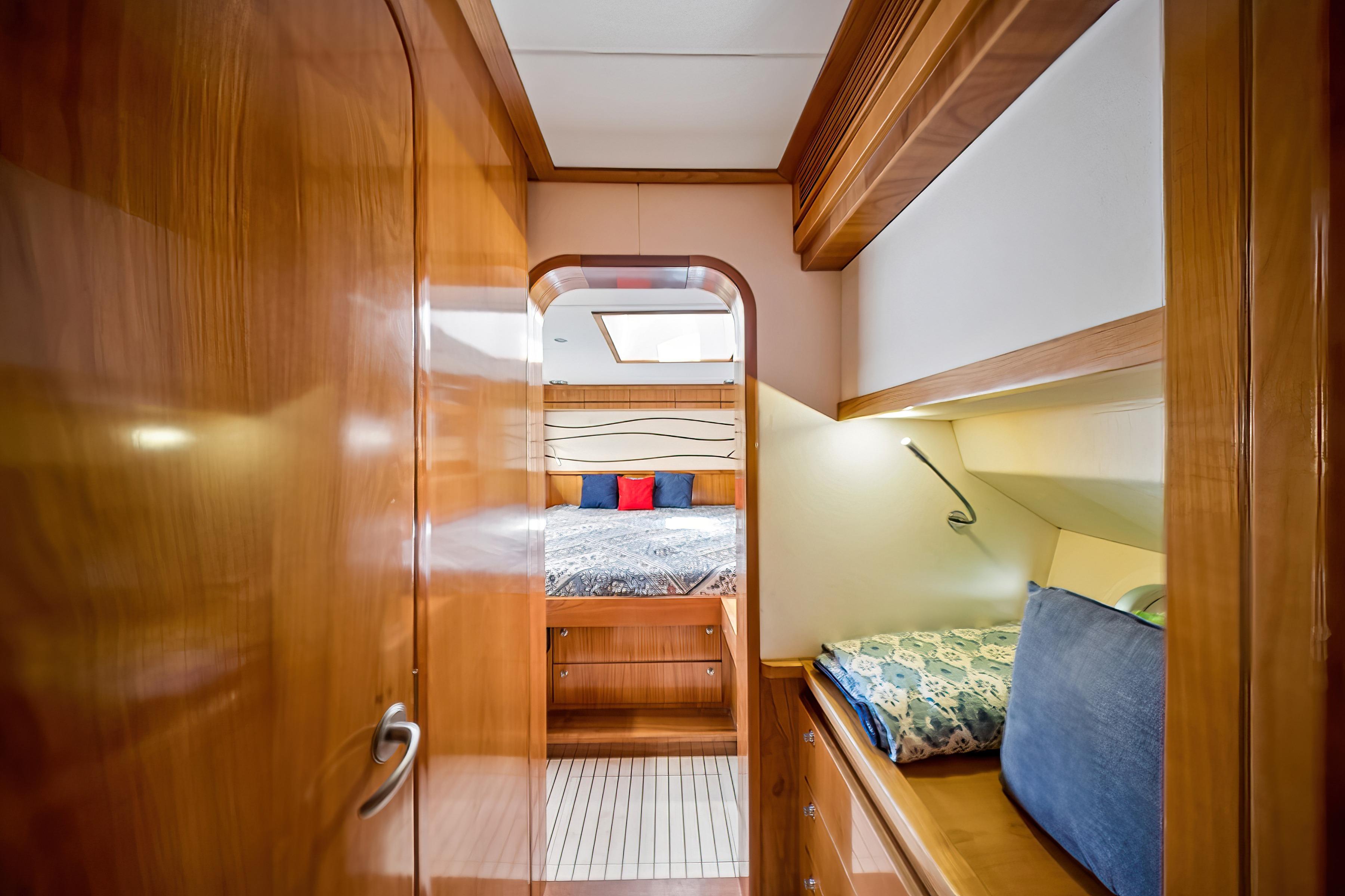 Luxurious wooden interior of 2009 Catana 65 yacht cabin with cozy bedding.