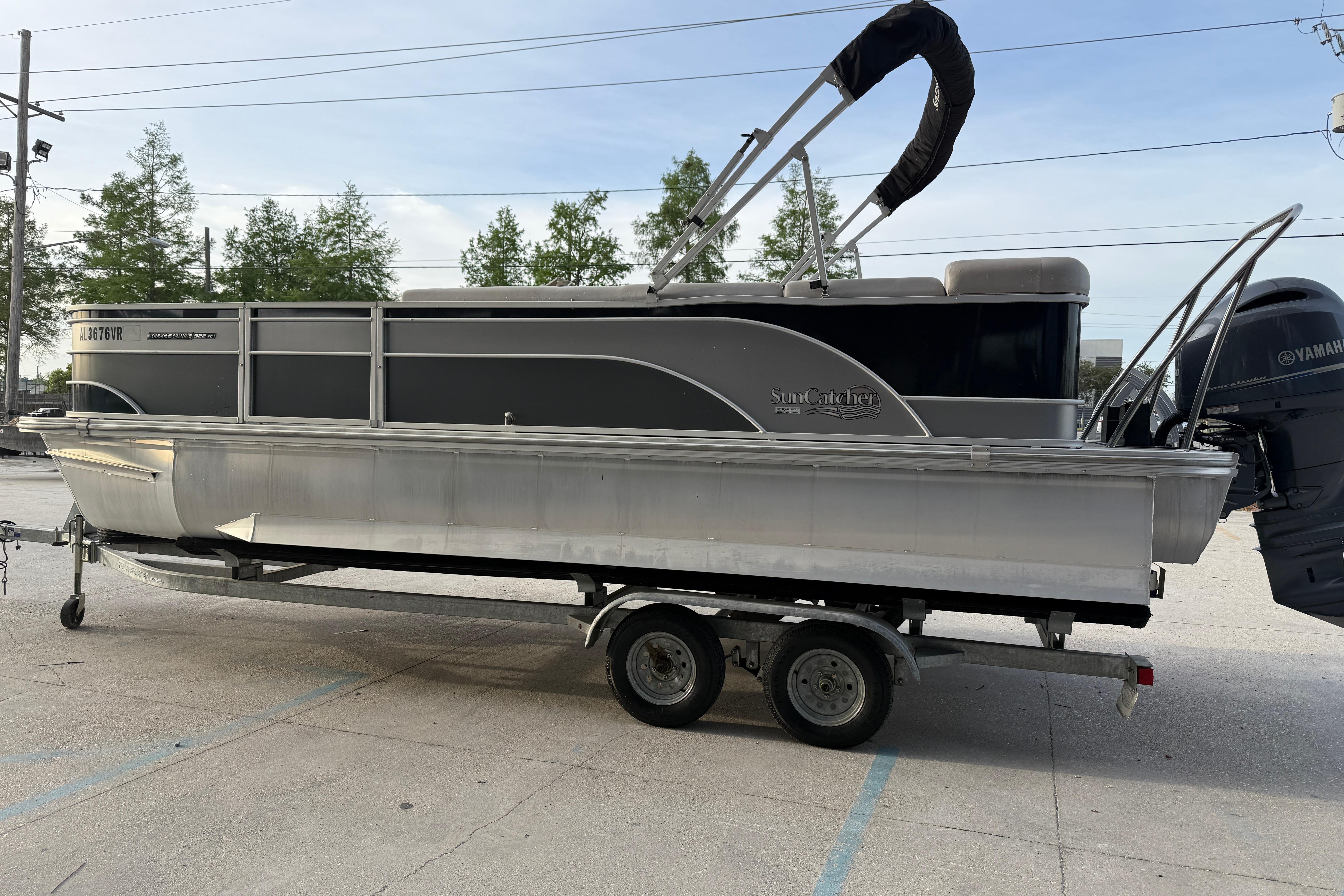 2022 Custom G3 Suncatcher 322FC pontoon boat on trailer, side view.