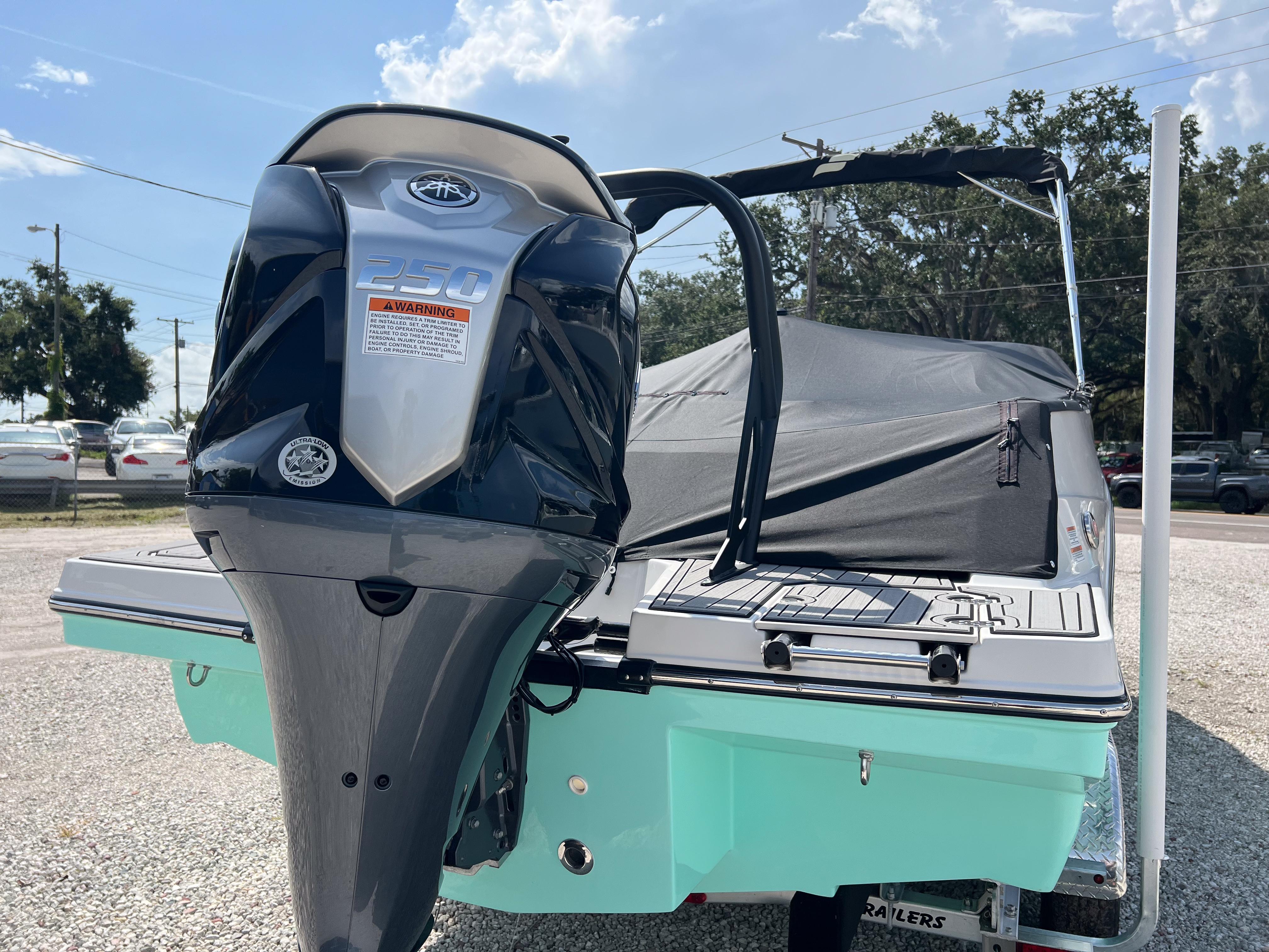 2026 Starcraft SVX 231 OB boat with powerful outboard motor, parked on gravel.