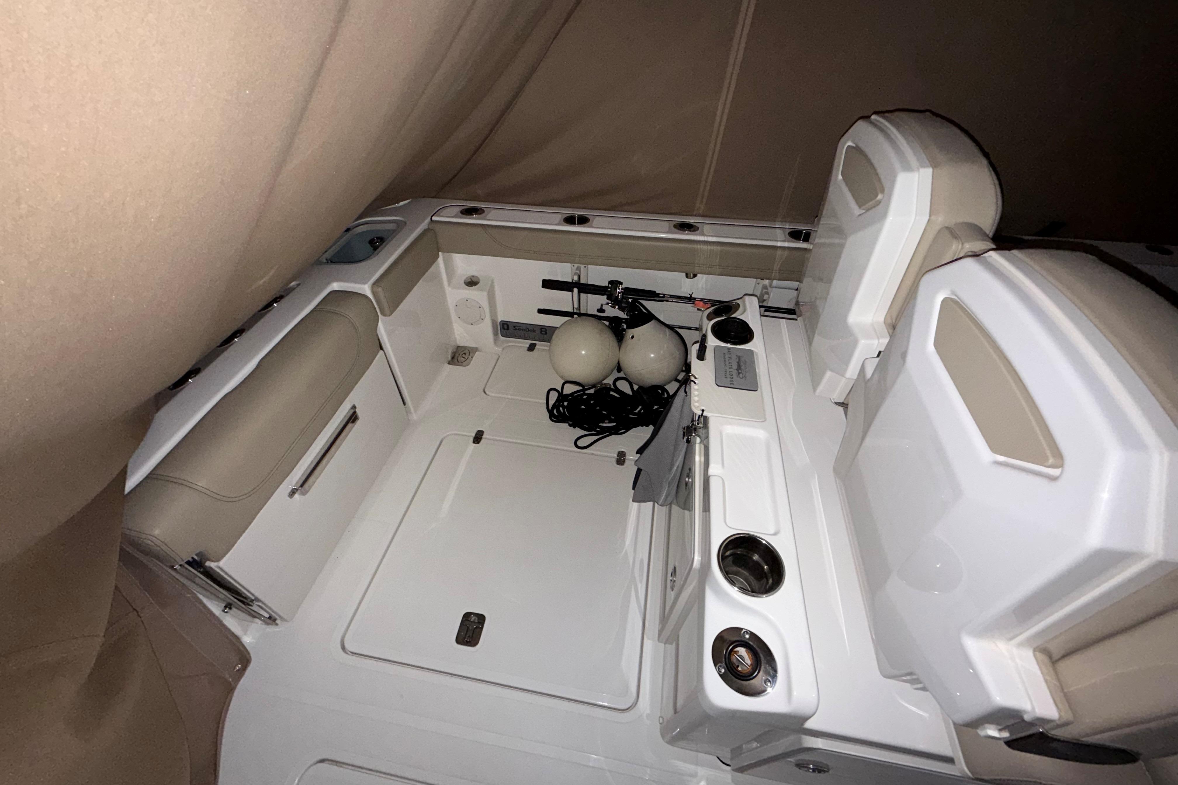 2021 Pursuit S 268 Sport boat interior with seating and storage compartments.