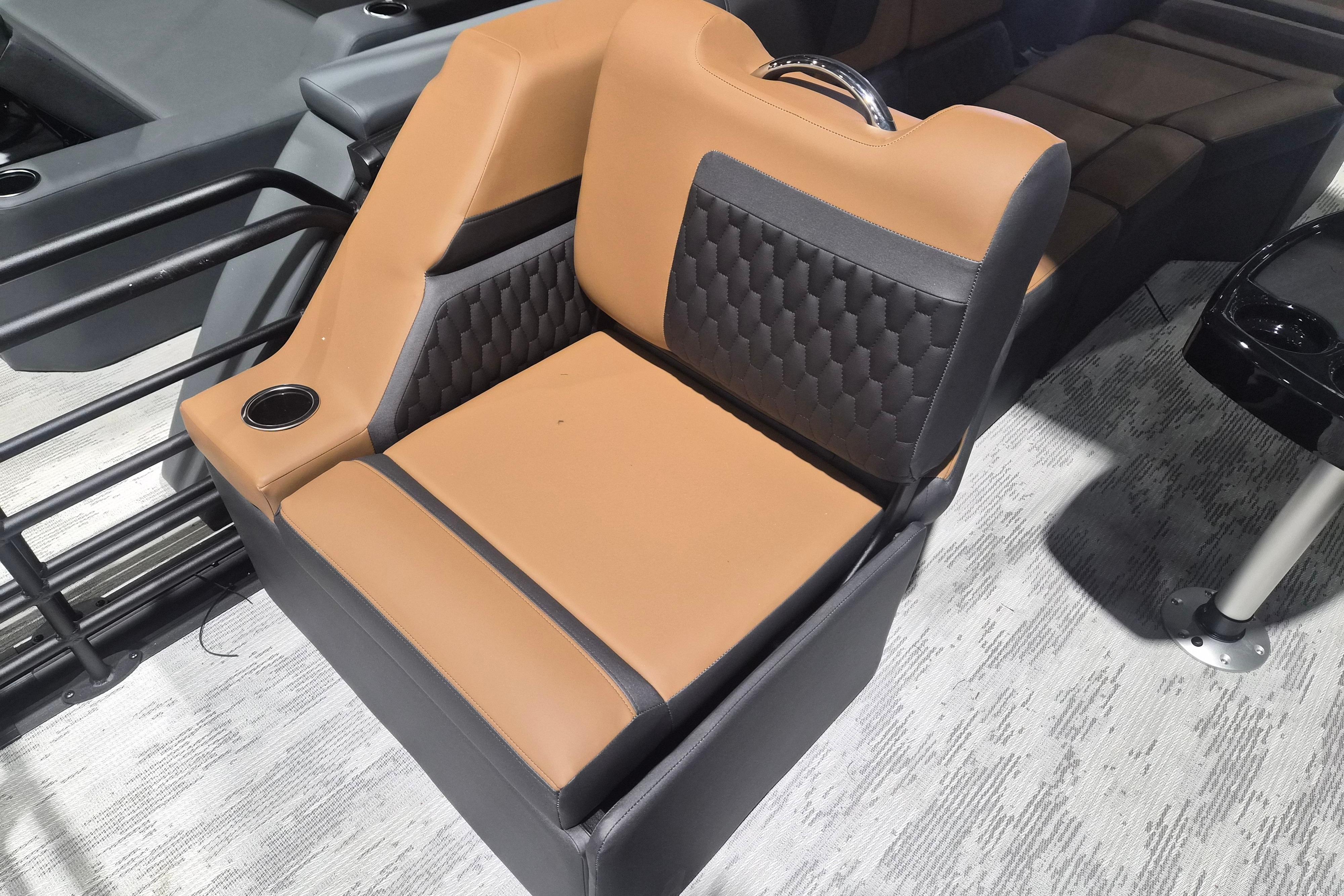 2026 Sylvan L3 SLZ boat seat with tan and black upholstery, featuring a cup holder.