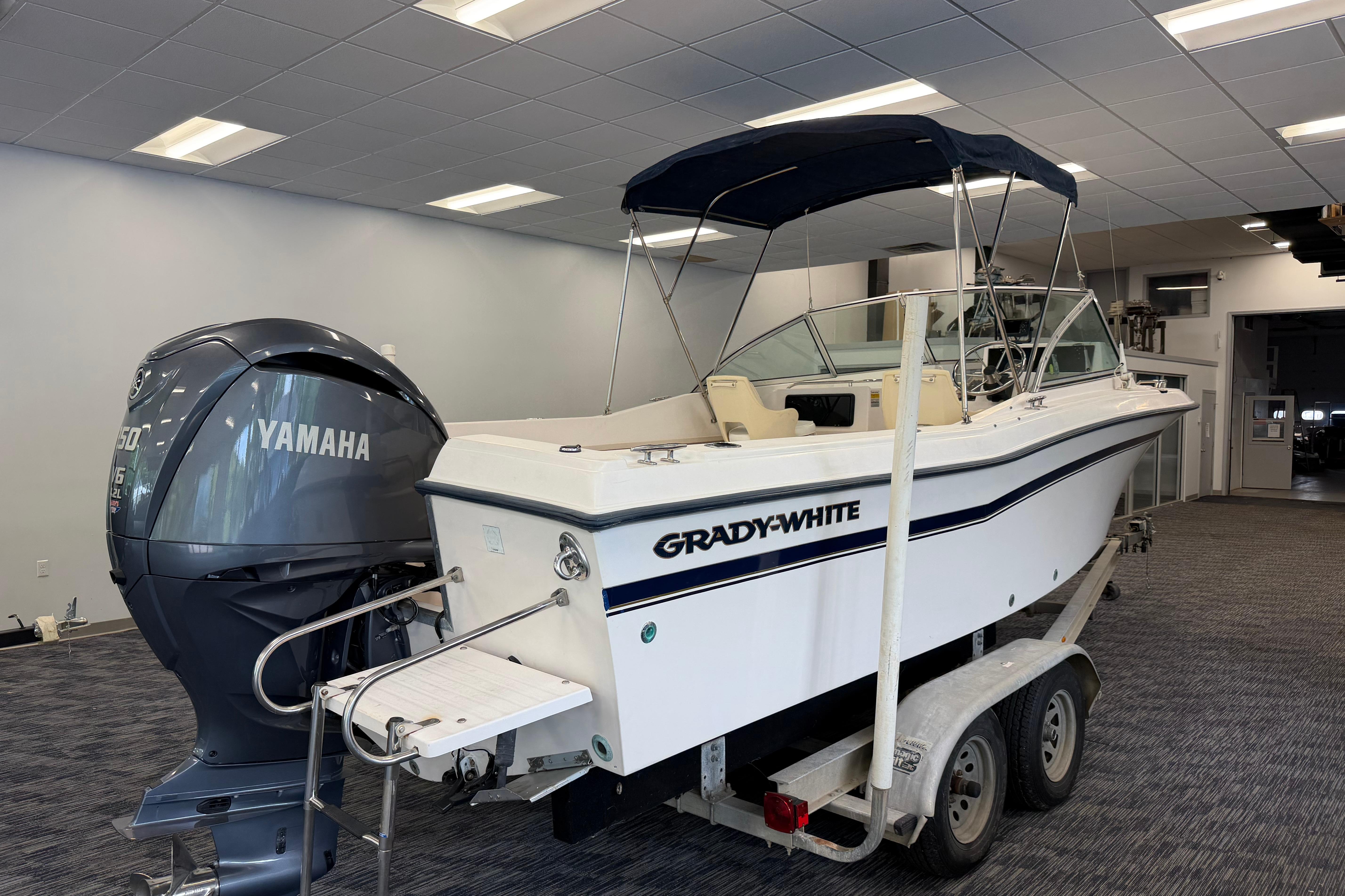 2001 Grady-White Tournament 223 boat with Yamaha engine on trailer indoors.