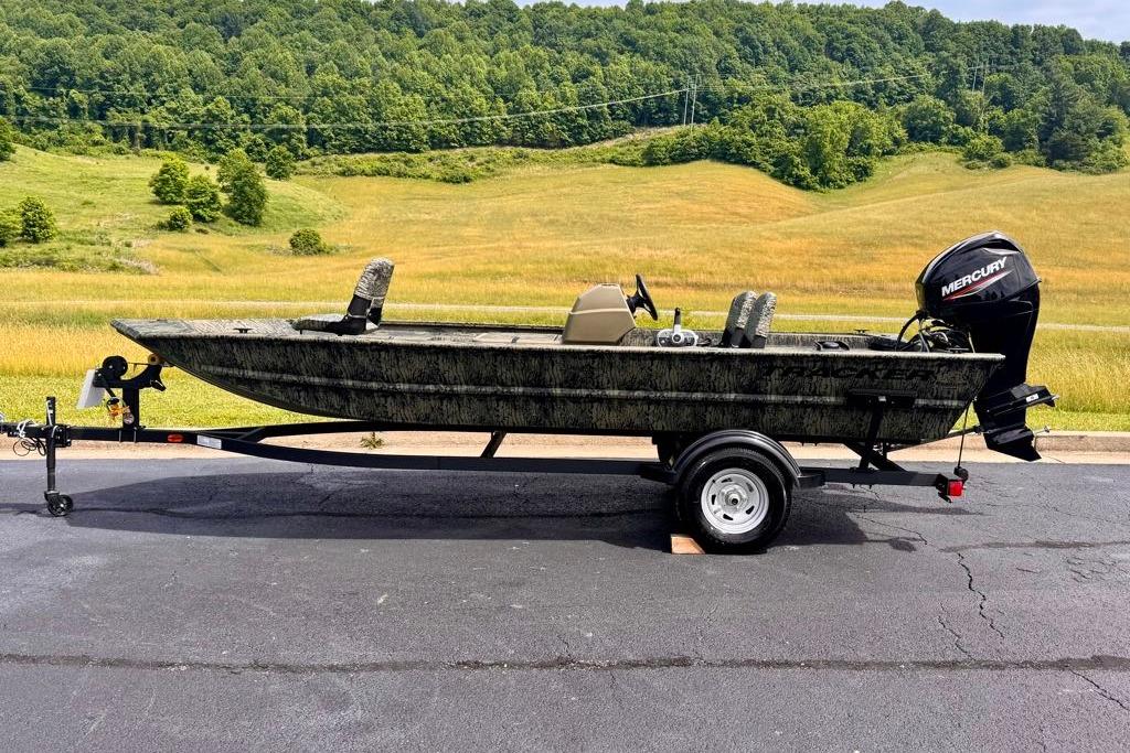 2026 Tracker Grizzly 1754 SC boat on trailer, scenic countryside background.