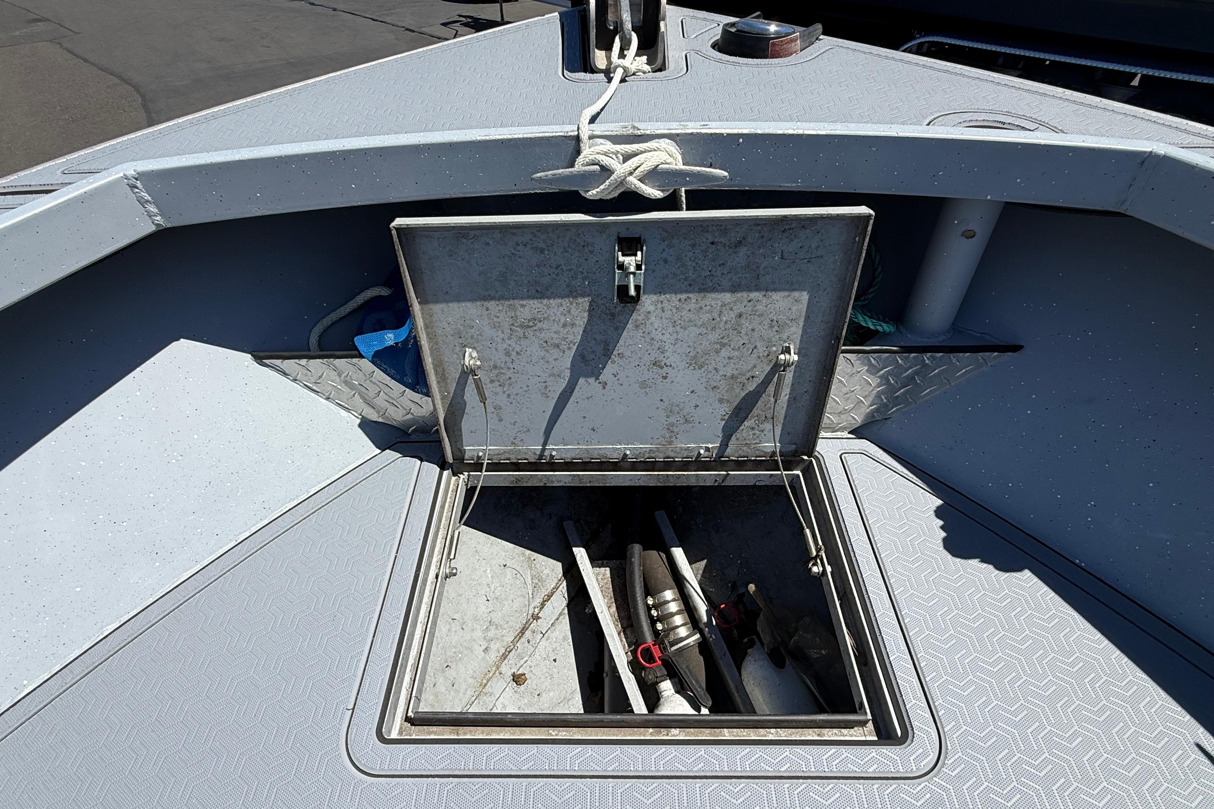Open storage compartment on 2015 Alumaweld Pacific XD 28 boat deck.