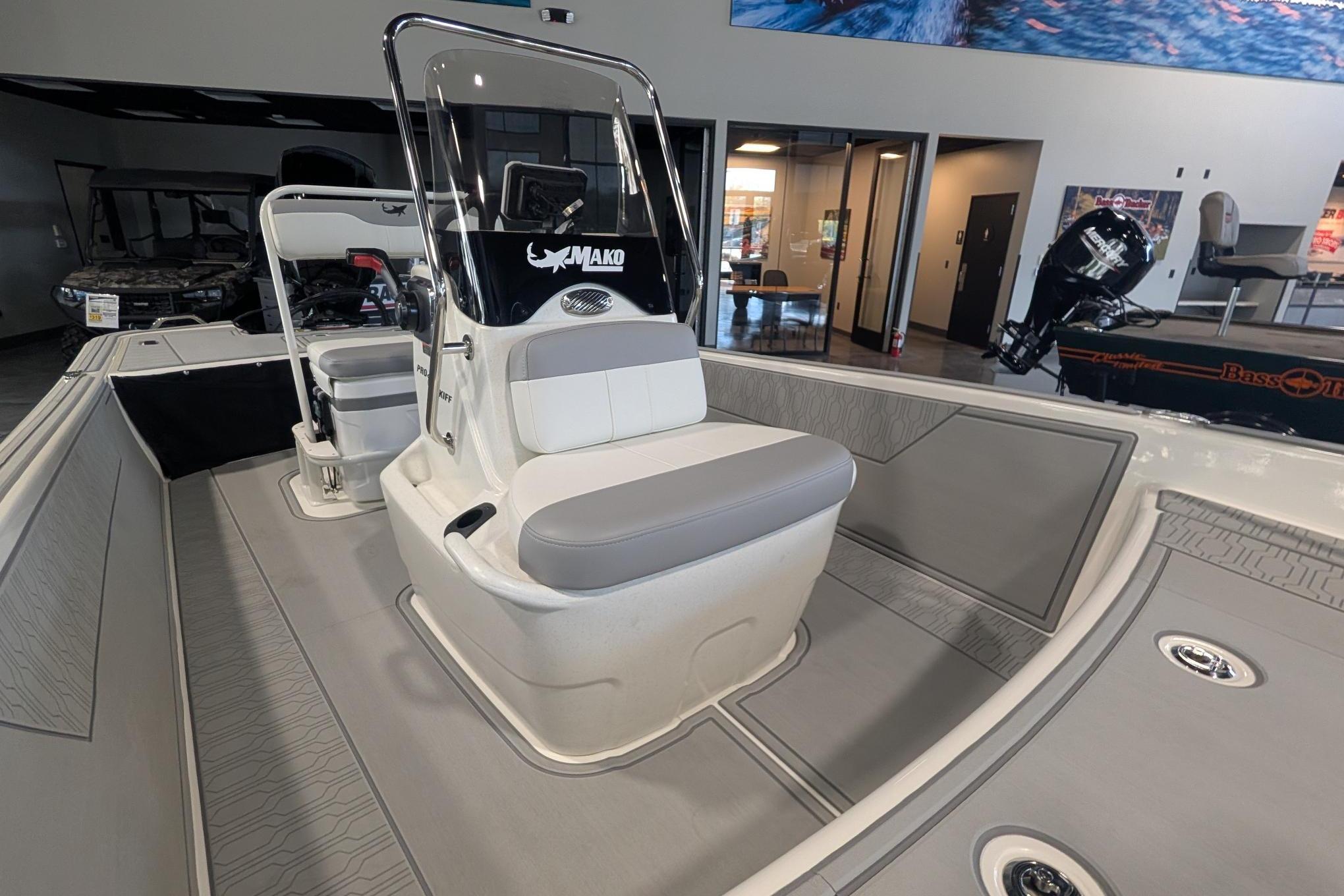 2026 Mako Pro Skiff 17 CC boat interior with console and seating in showroom.