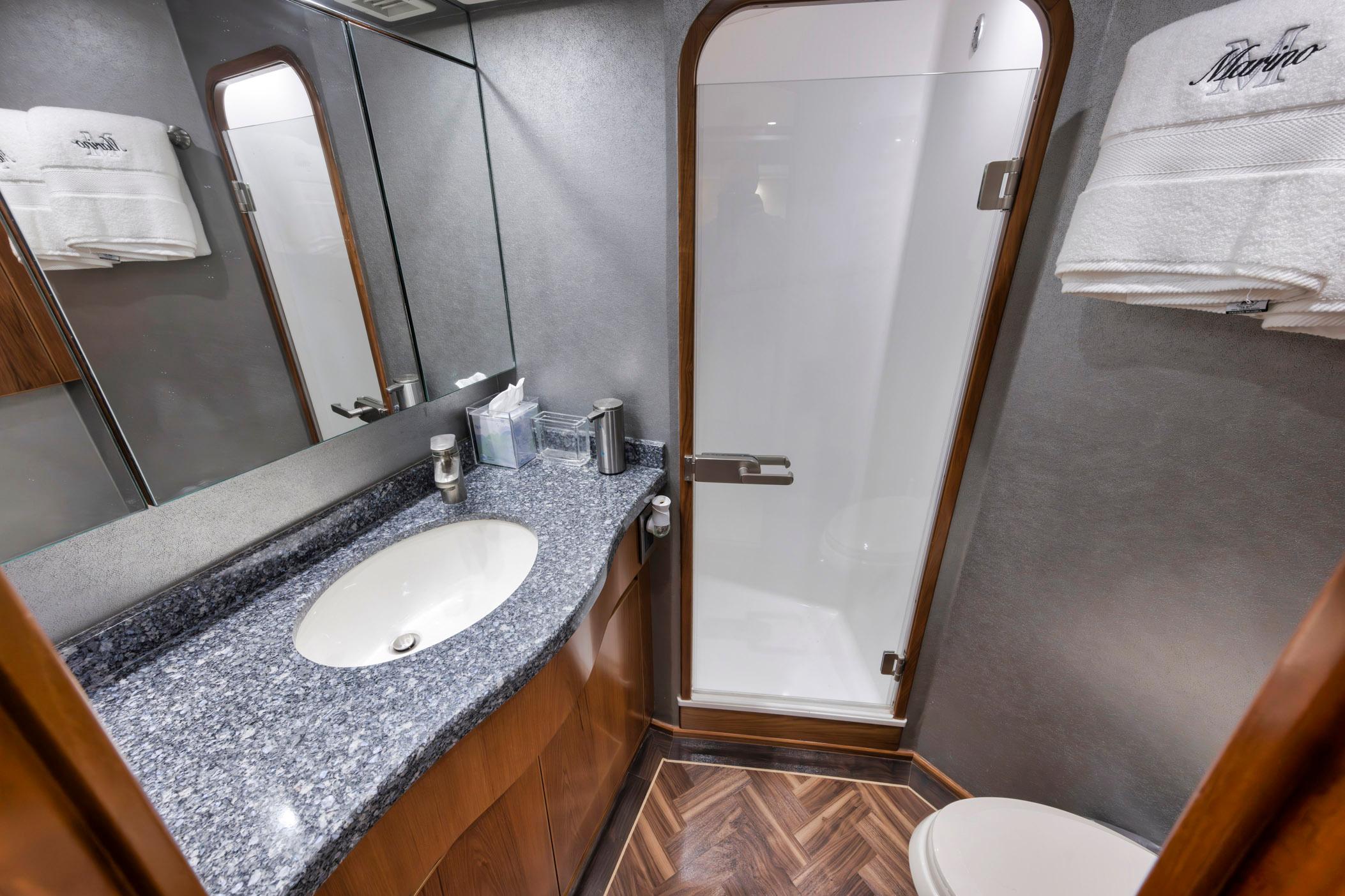Luxurious bathroom in 2015 Viking 70 Convertible yacht with modern fixtures and elegant design.