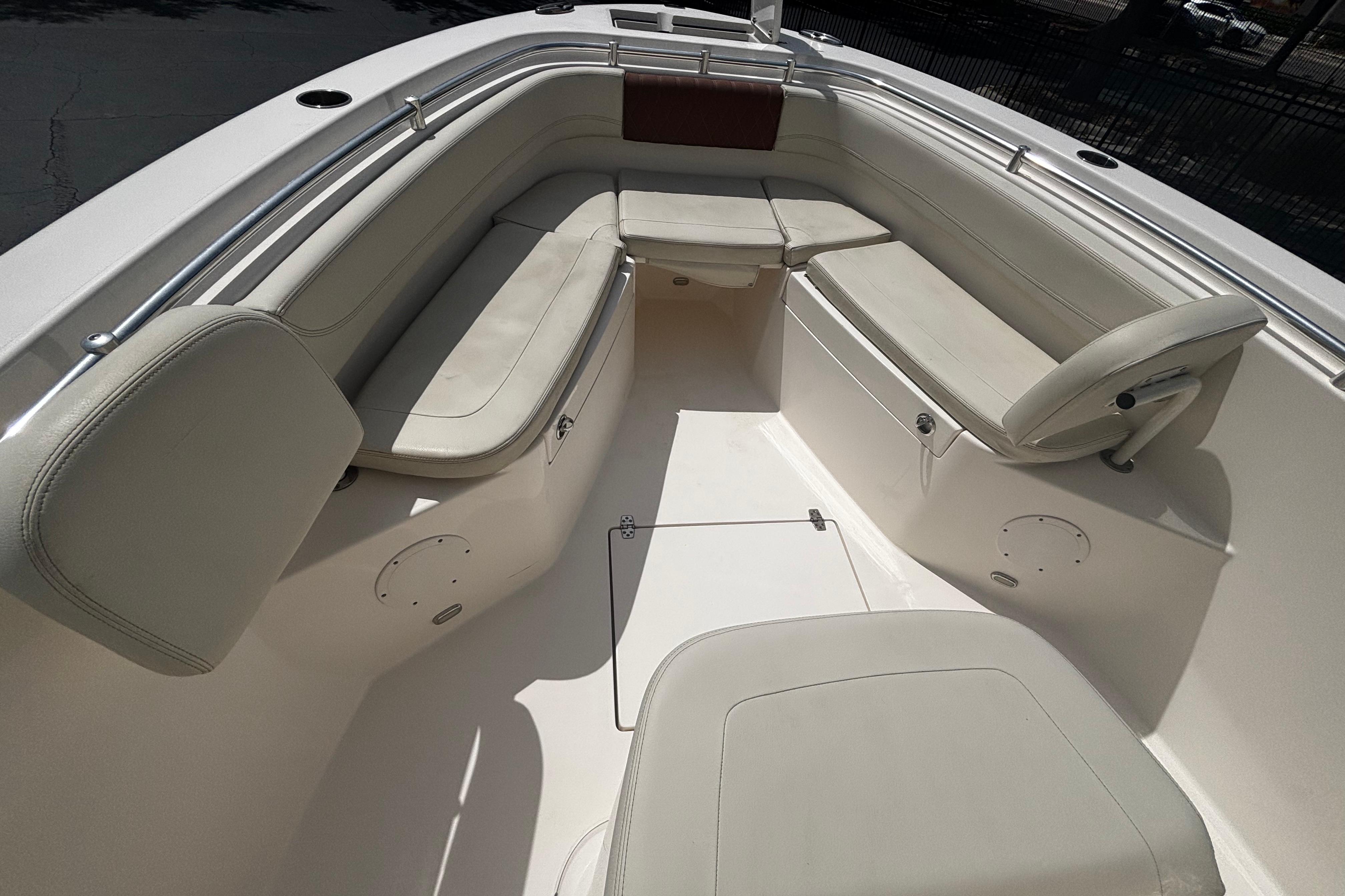 2023 Cobia 262 Center Console boat interior with cushioned seating and storage compartments.