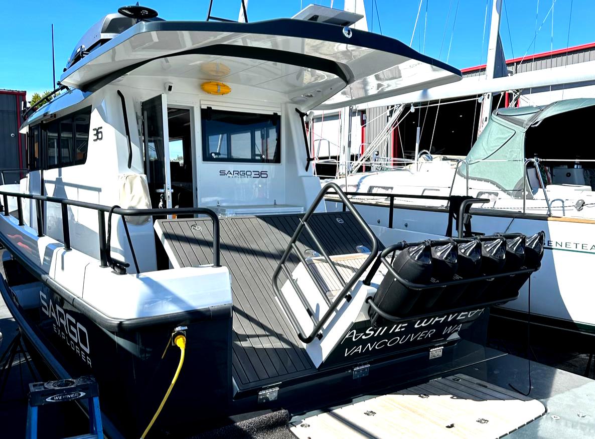 2024 Sargo 36 Explorer docked, rear view with open deck and railing.