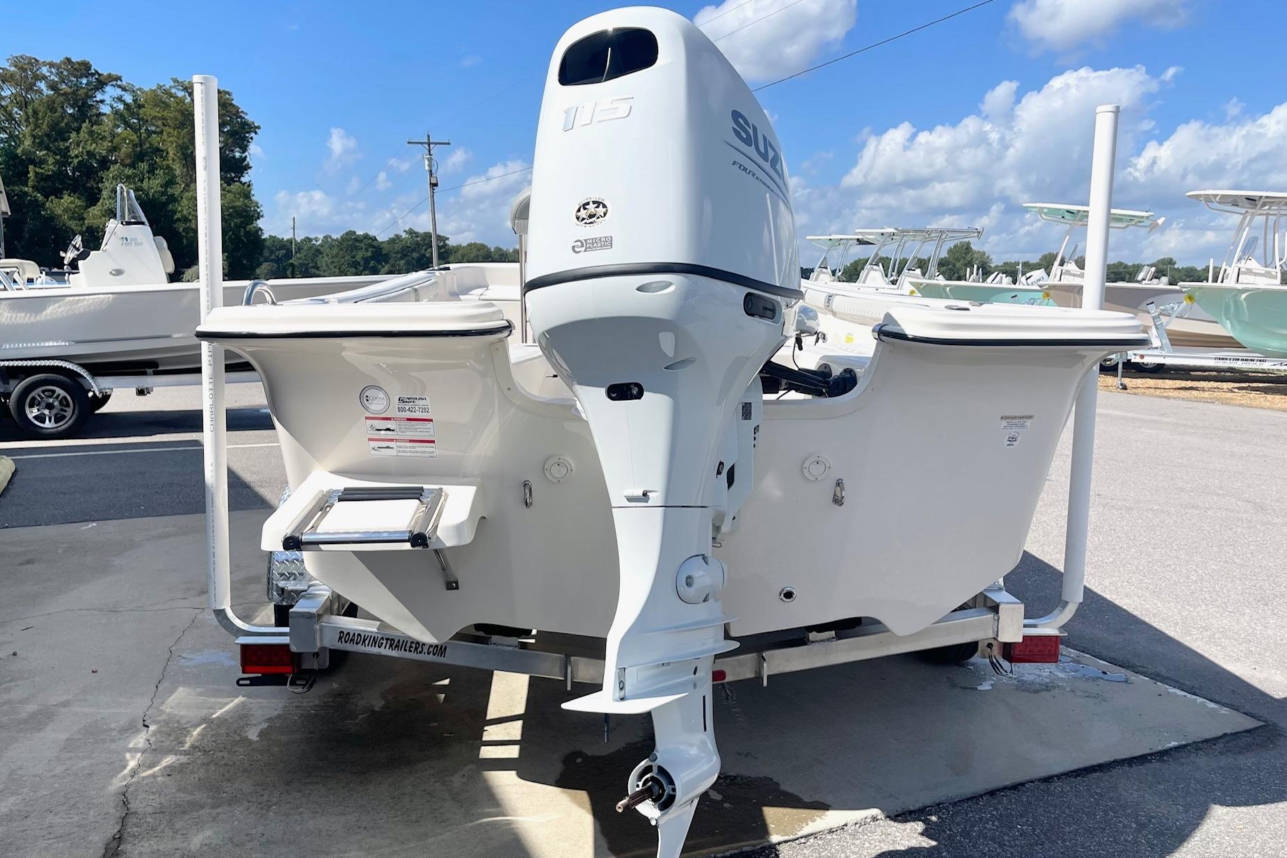2026 Carolina Skiff 19 LS boat with Suzuki outboard motor, parked on a trailer.