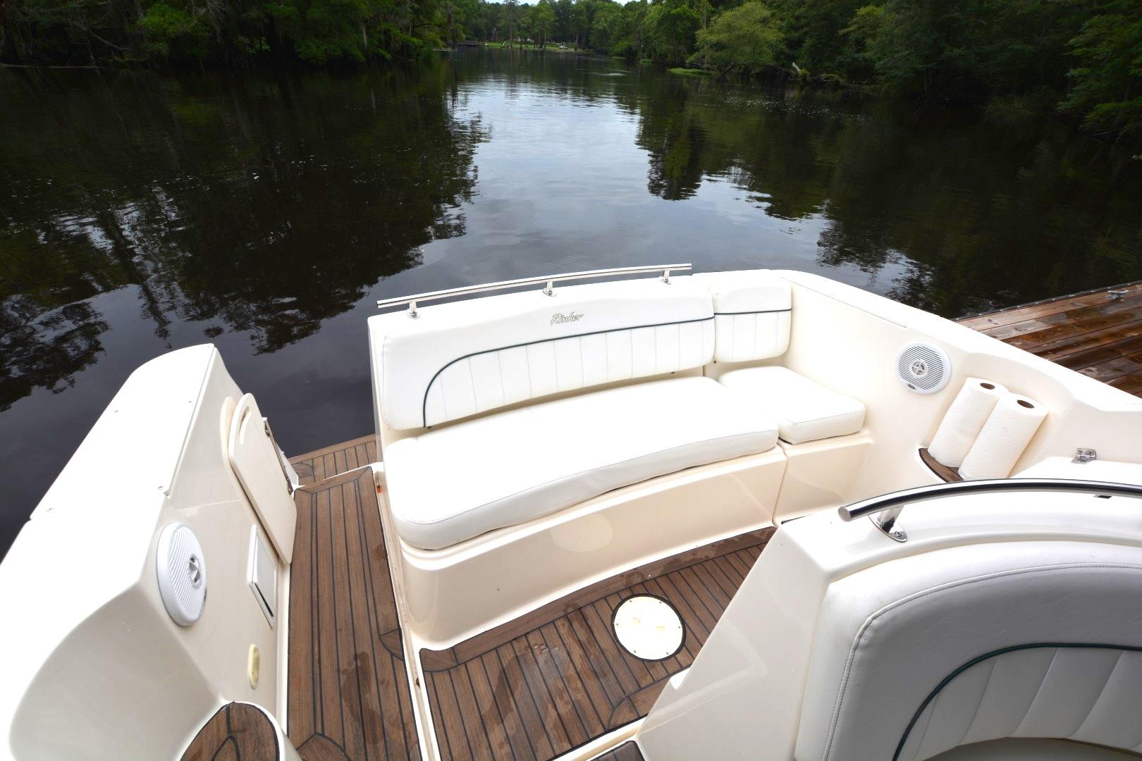 1999 Rinker 270 Fiesta Vee boat interior with white seating and wooden deck.