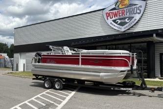 2026 Sun Tracker SportFish 20 DLX pontoon boat on trailer outside Power Pros store.