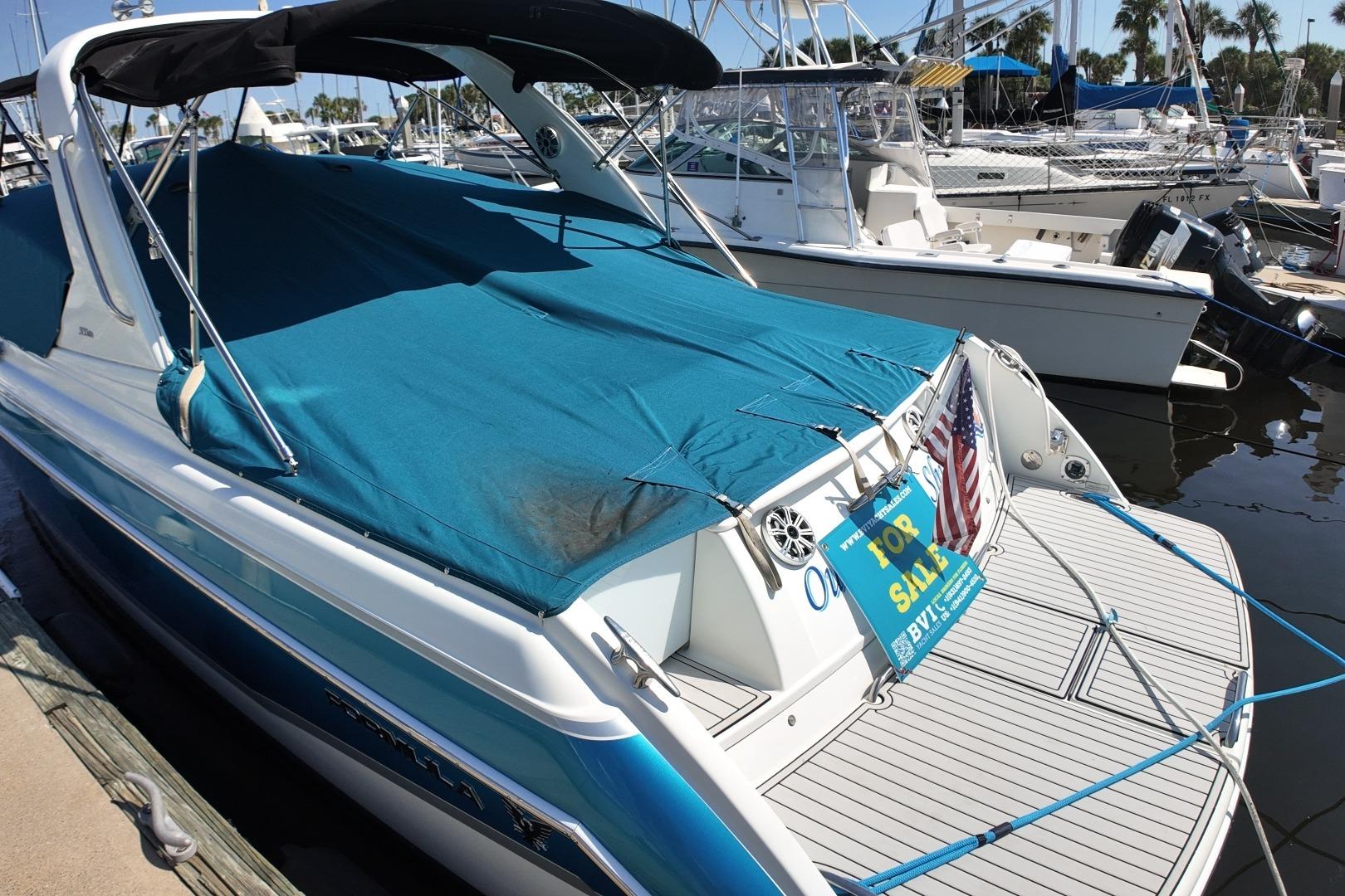 2007 Formula 330 Sun Sport boat with blue cover, docked and for sale.
