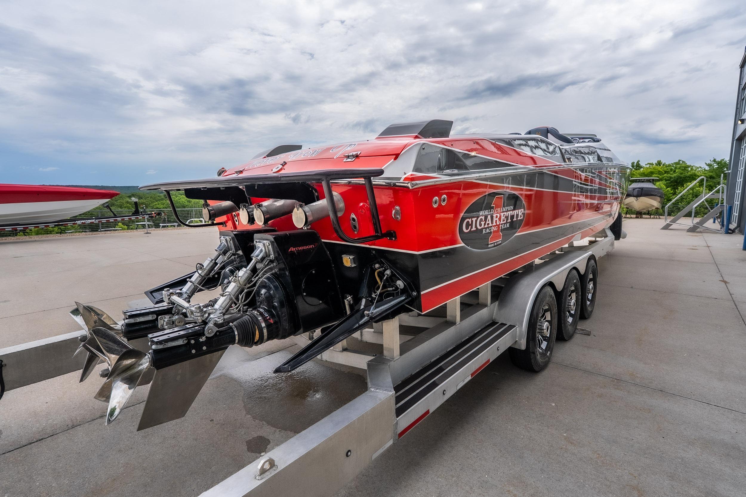 2006 Cigarette 39' Top Gun Unlimited speedboat on trailer, showcasing powerful engines.