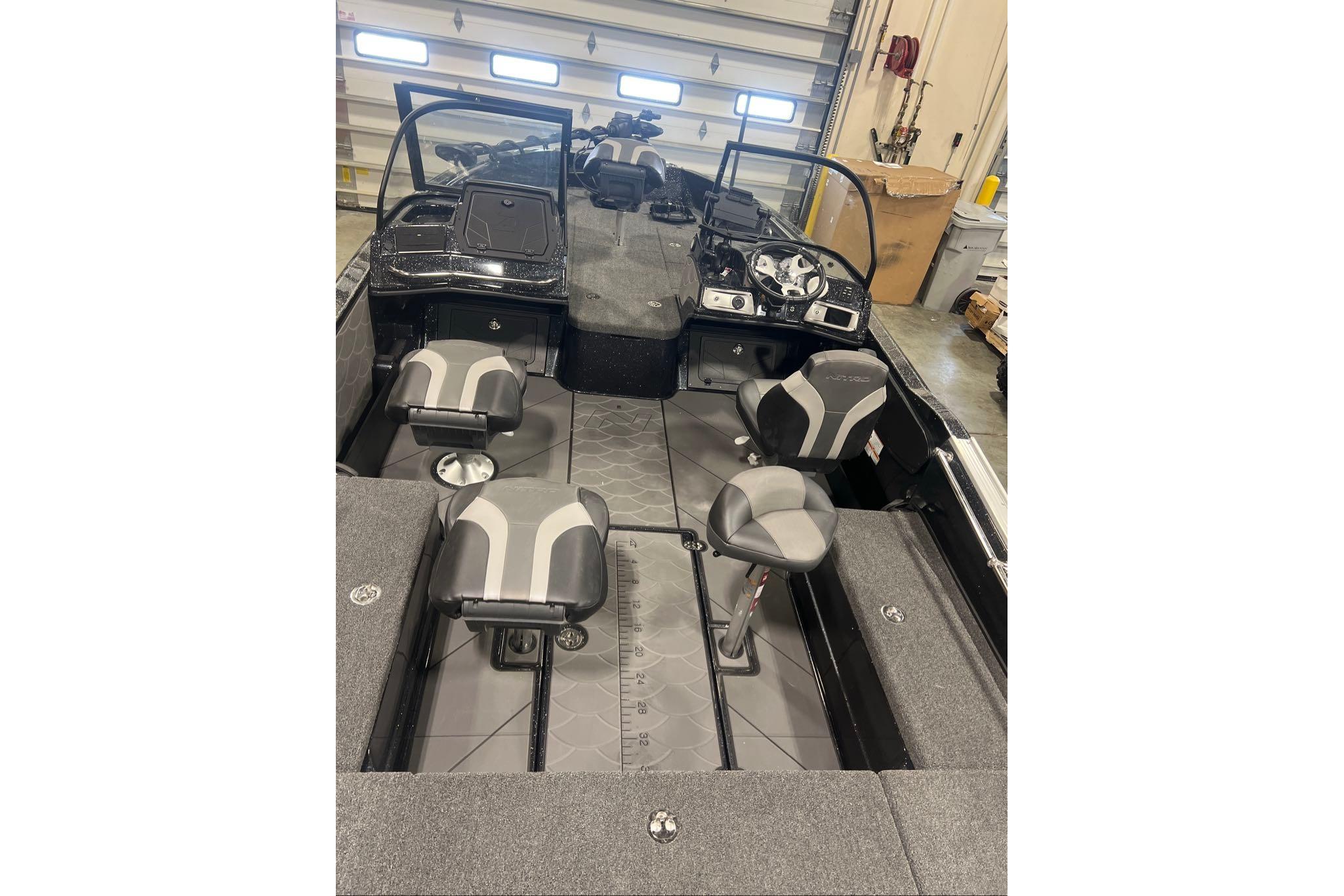2026 Nitro ZV20 Pro boat interior with modern seating and dashboard in a garage setting.