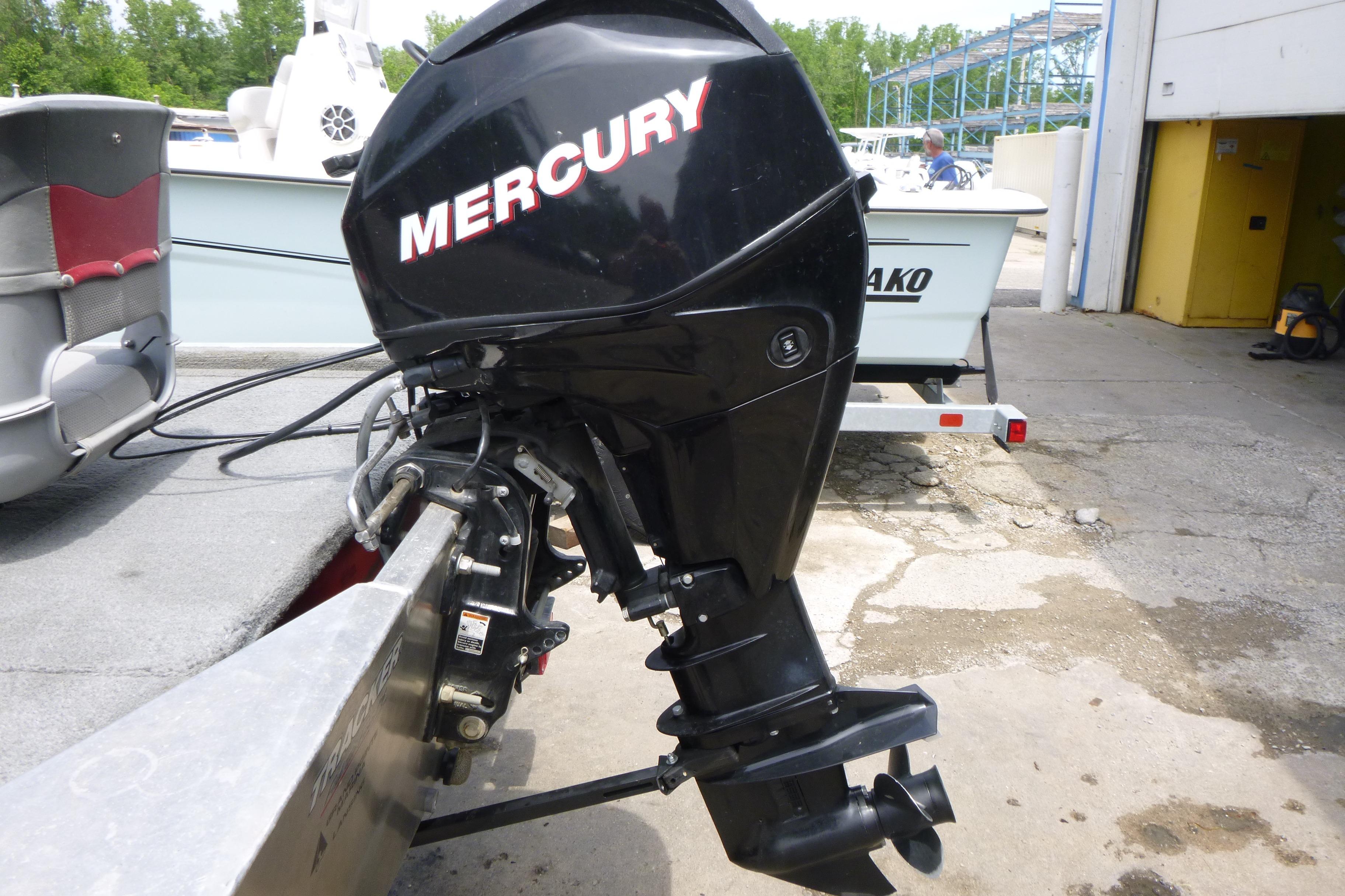 2011 Tracker Pro Angler 16 with Mercury outboard motor in a marina setting.
