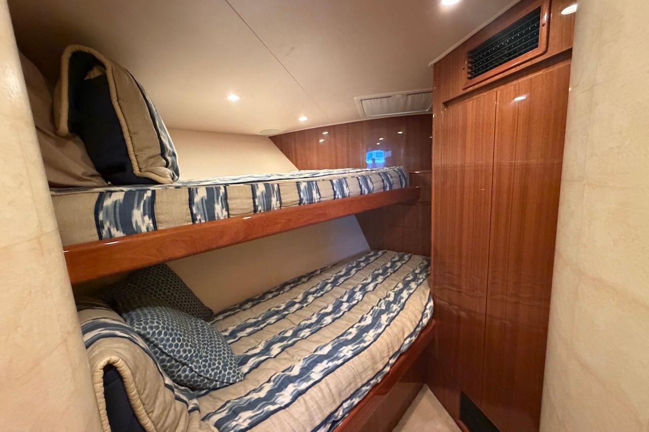 Bunk beds in 2012 Viking 50 Convertible yacht cabin with wood paneling.