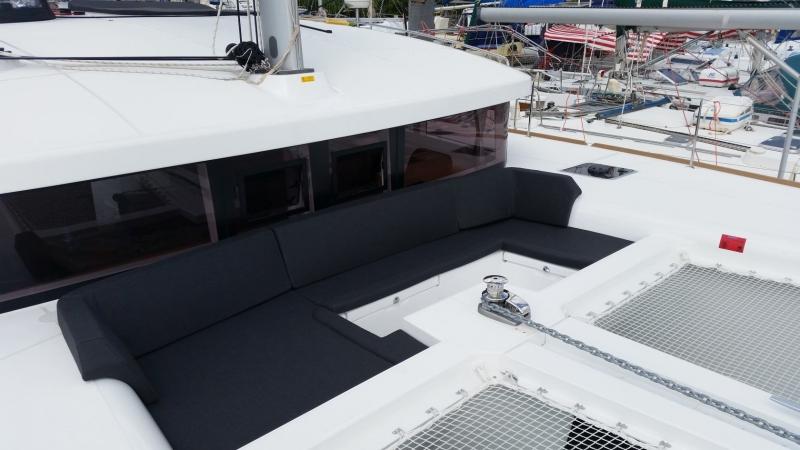 2017 Lagoon 450S catamaran with spacious deck seating and netting, docked at a marina.