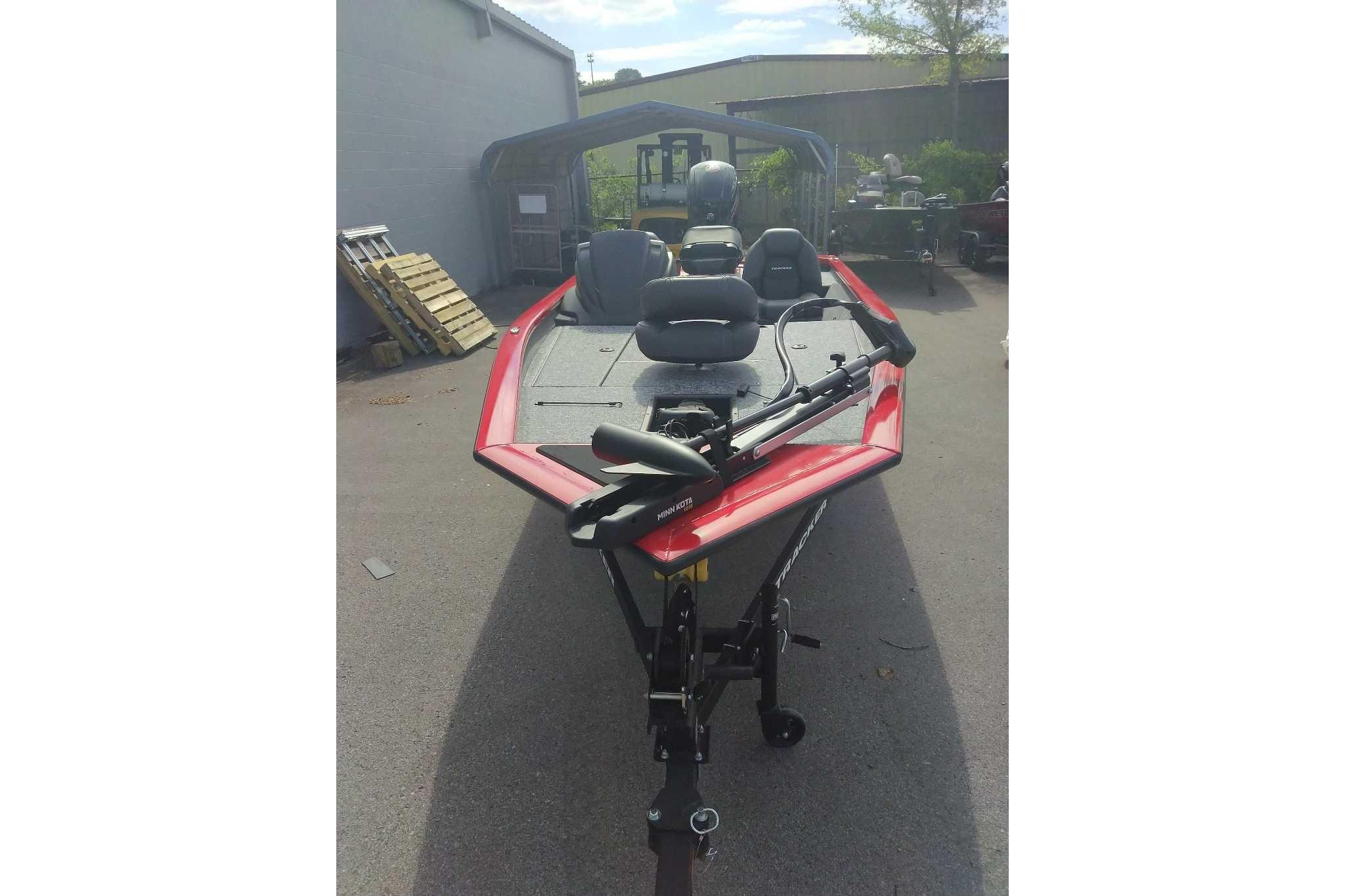 2026 Tracker Pro Team 190 boat with red trim, parked outdoors.
