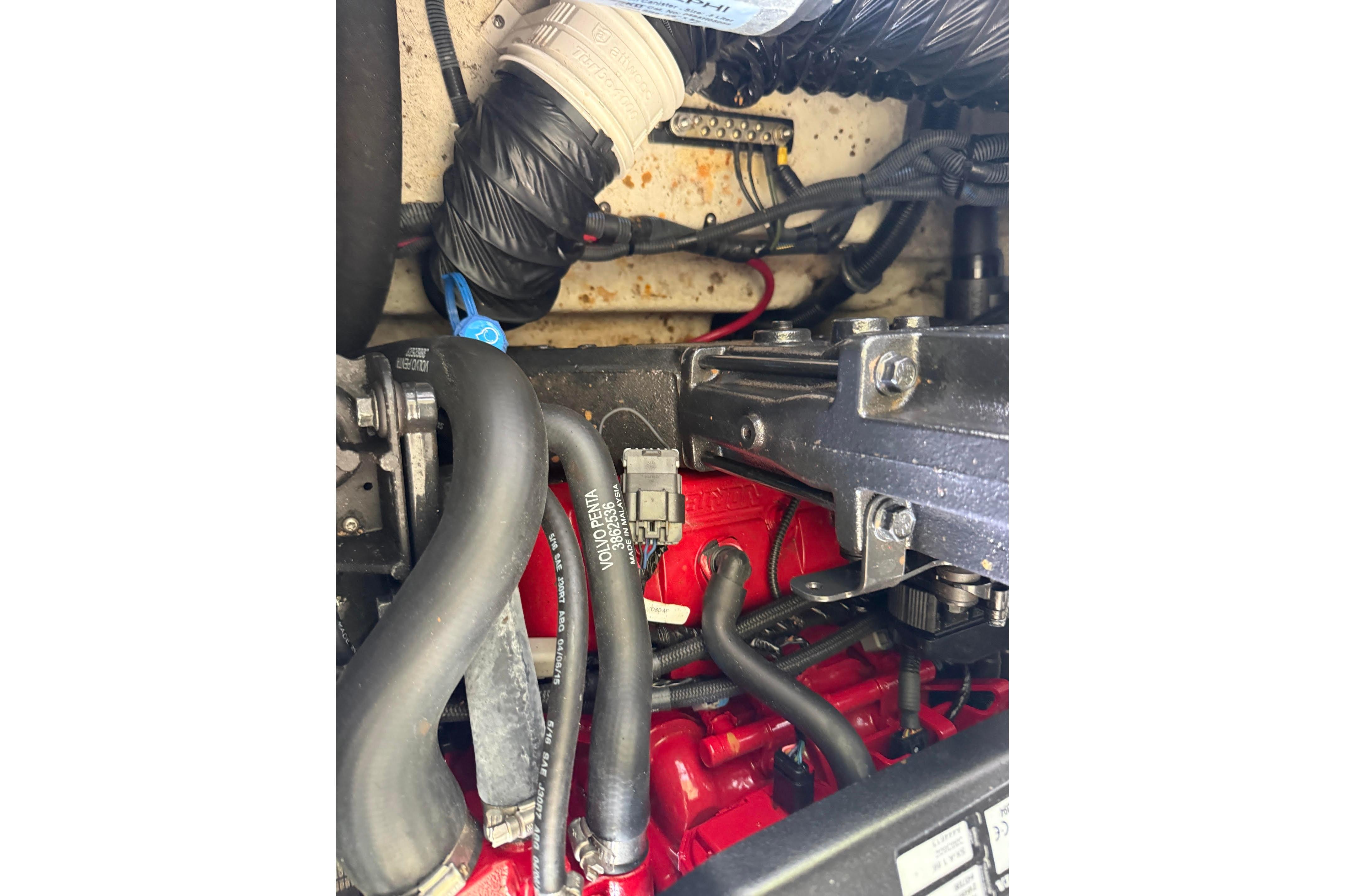 Engine compartment of a 2016 Regal 1900 ES Bowrider, showcasing hoses and components.