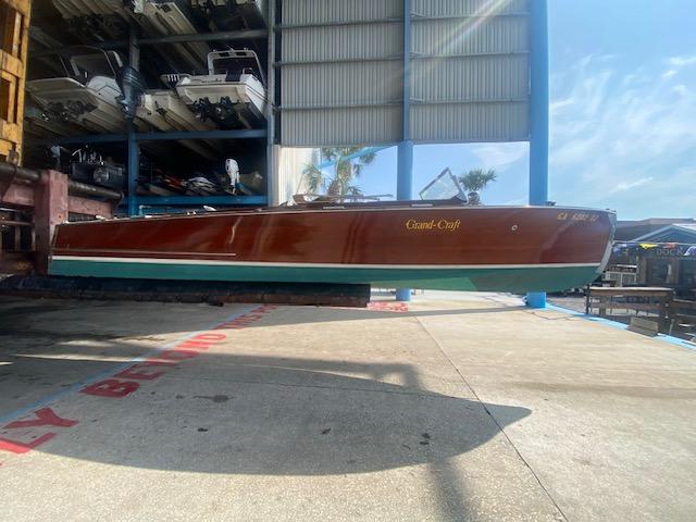2000 Grand Craft Classic Runabout boat in storage facility, side view.