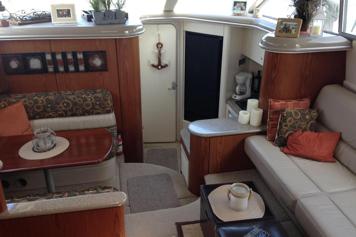 Luxurious interior of a 1999 Maxum 4100 SCA yacht with elegant seating and decor.