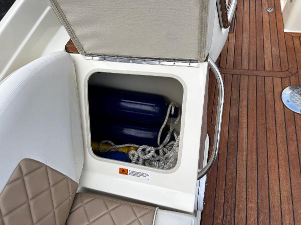 Storage compartment on a 2014 Chris-Craft 28 LAUNCH boat with ropes and fenders.