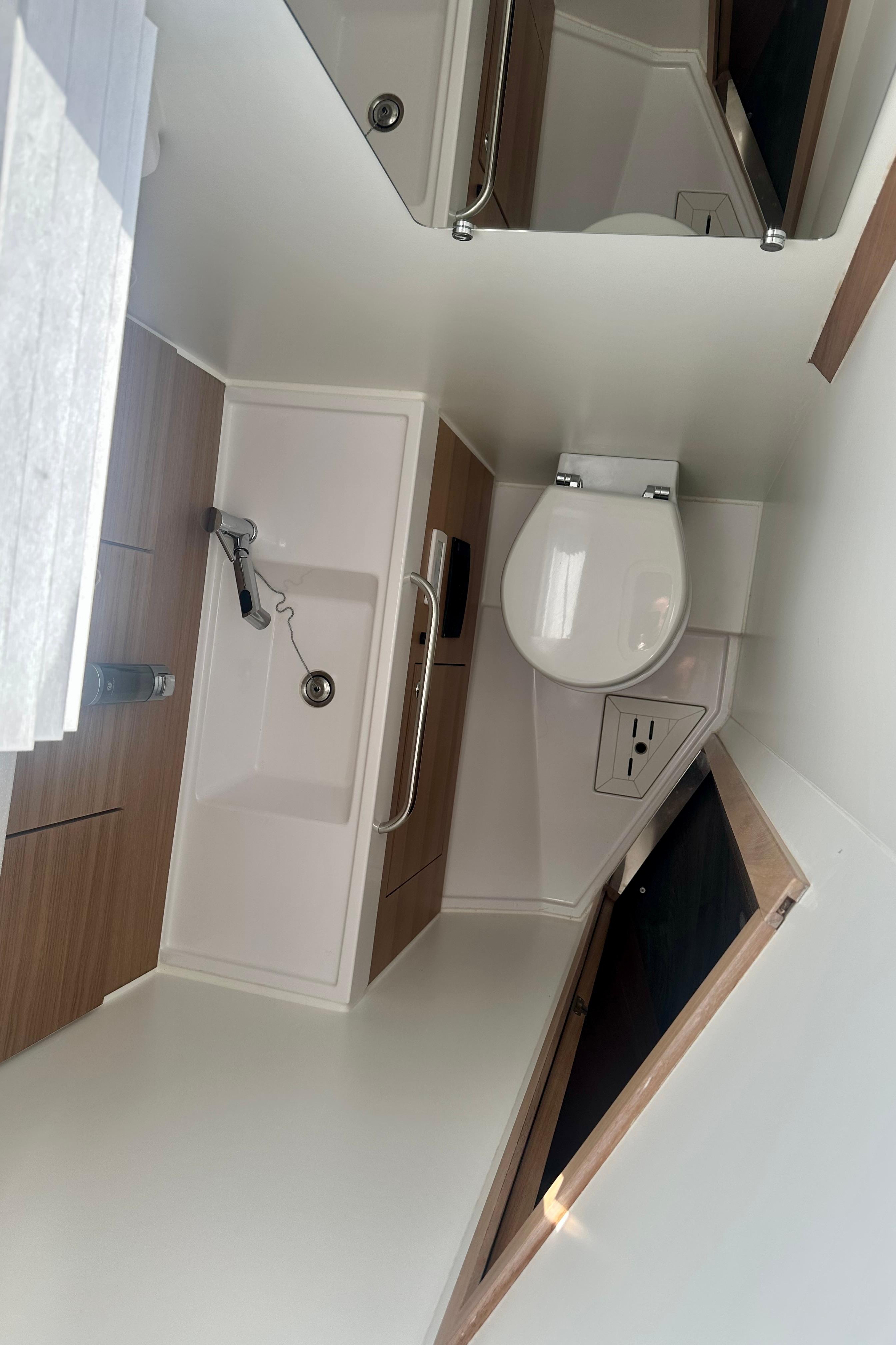 2022 Elan Impression 50.1 yacht bathroom with modern fixtures and wooden accents.